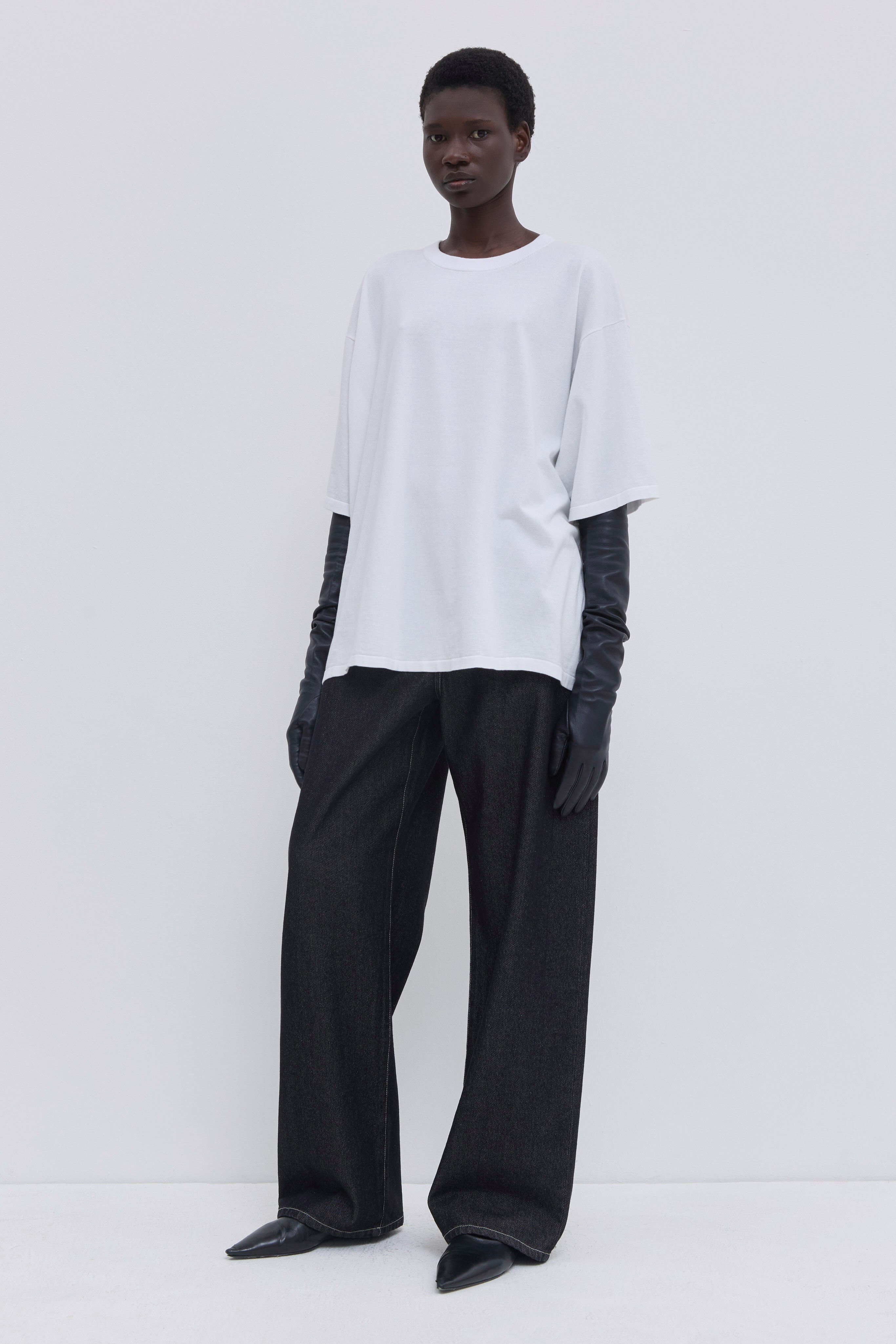 Front view of a white 100% cotton oversized jersey knit T-shirt with relaxed fit.