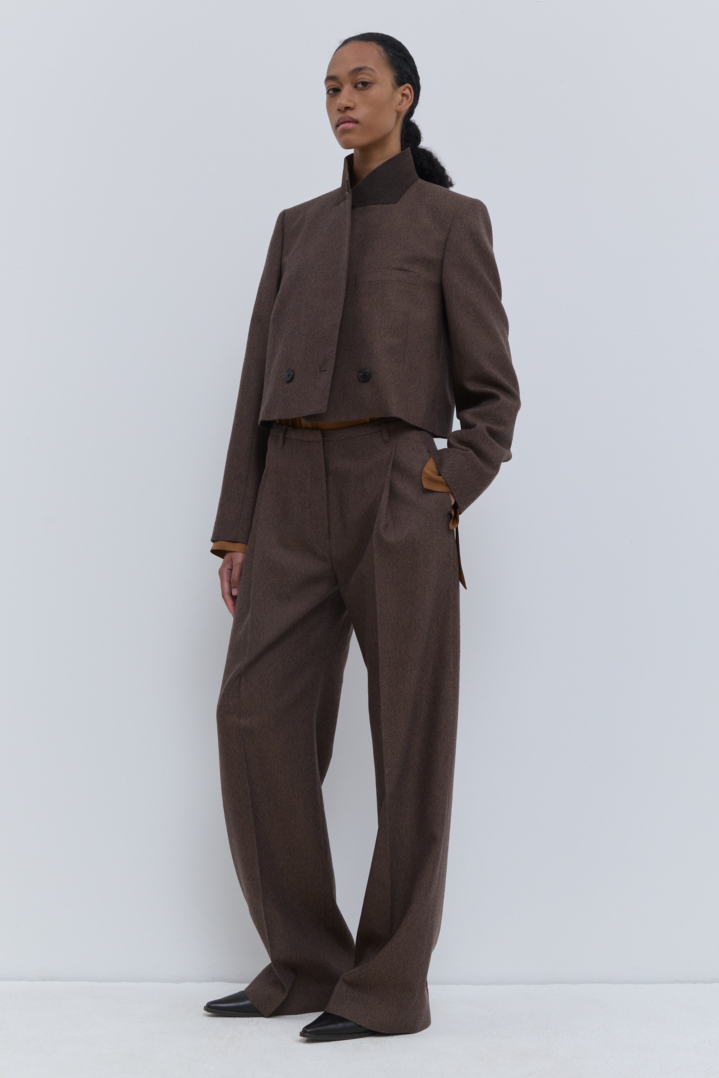 Christian Wijnants Pamira low-waist trousers in rust brown virgin wool tweed with a relaxed wide-leg silhouette.