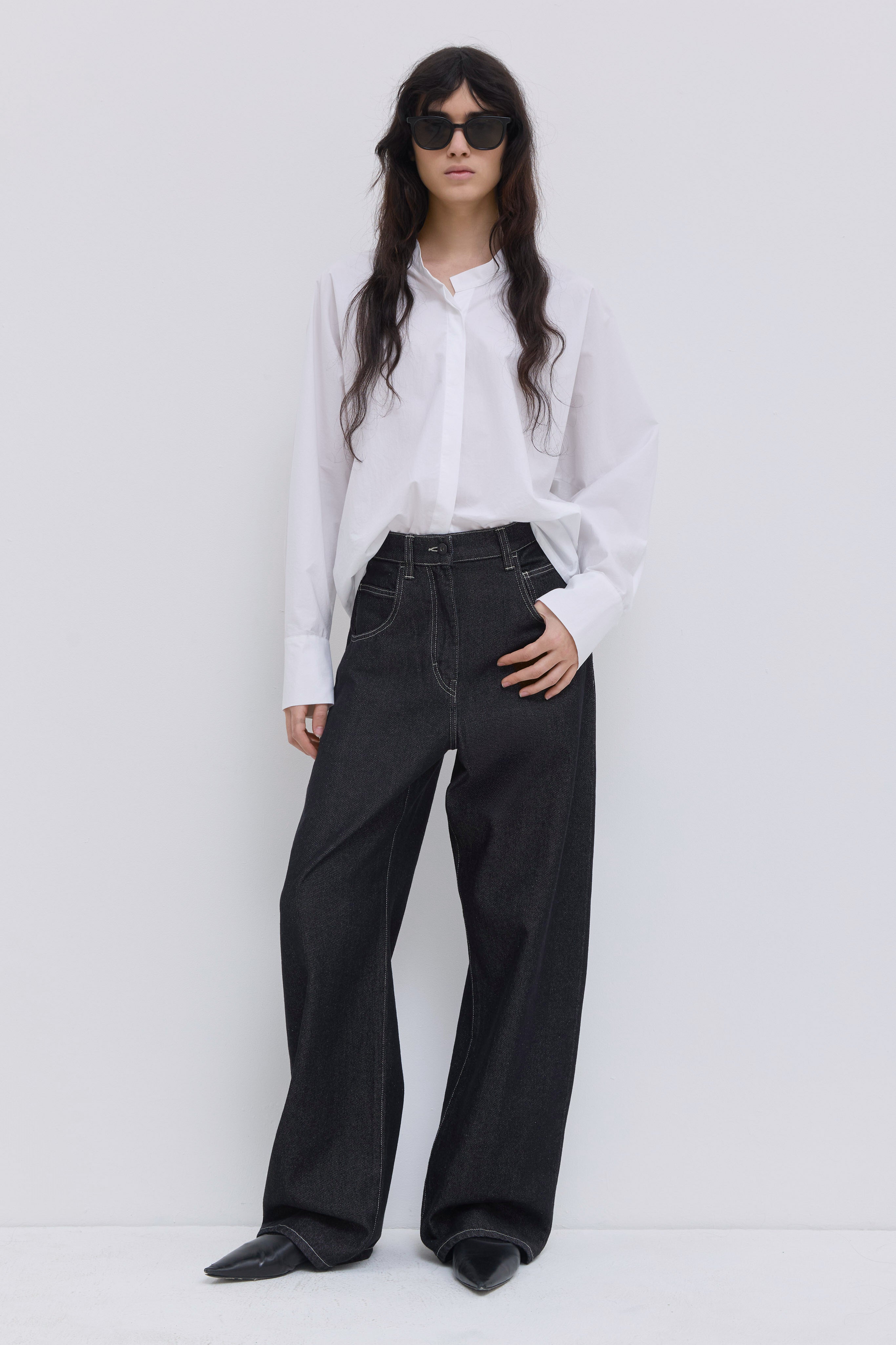 Patan wide-leg raw denim jeans with high-rise waist and contrast stitching.
