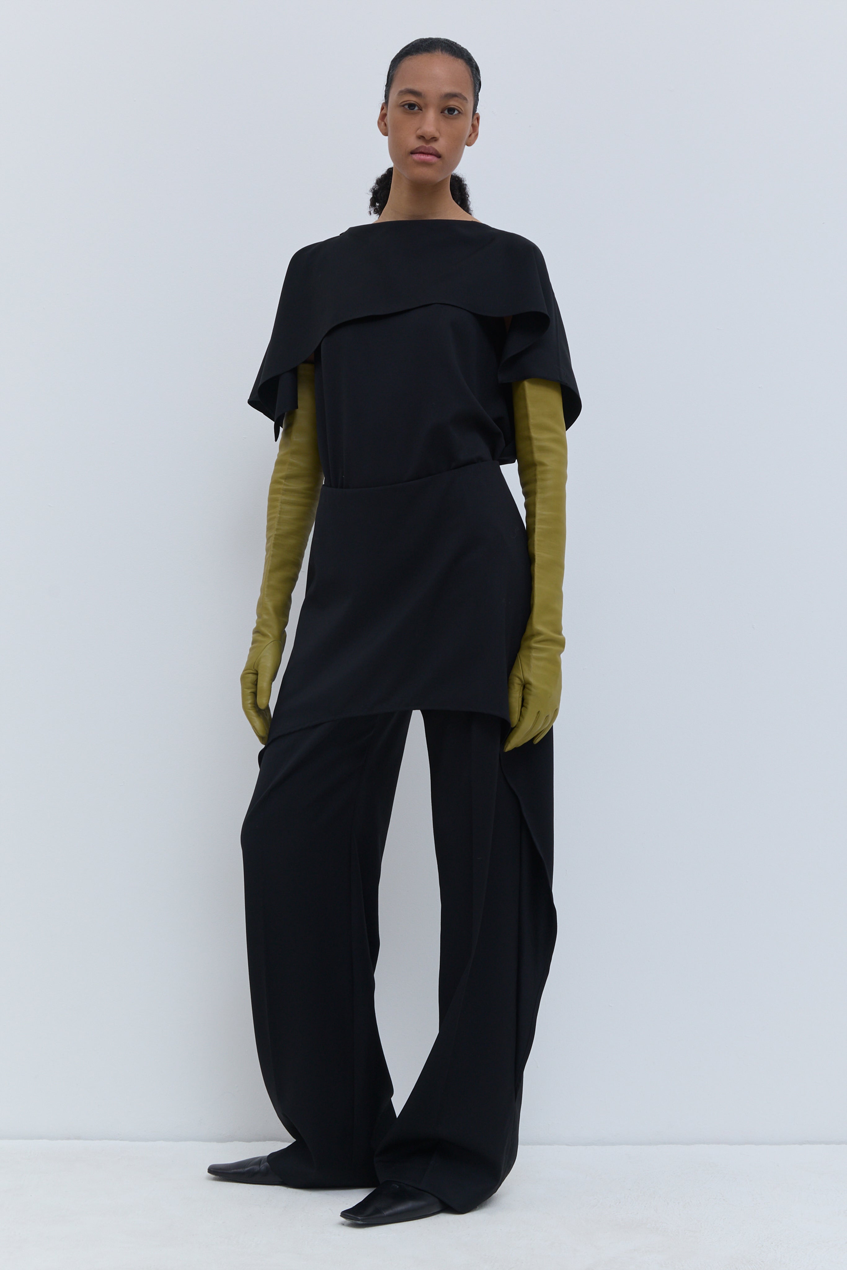 Christian Wijnants wide-leg black wool trousers with a layered skirt overlay and tailored silhouette