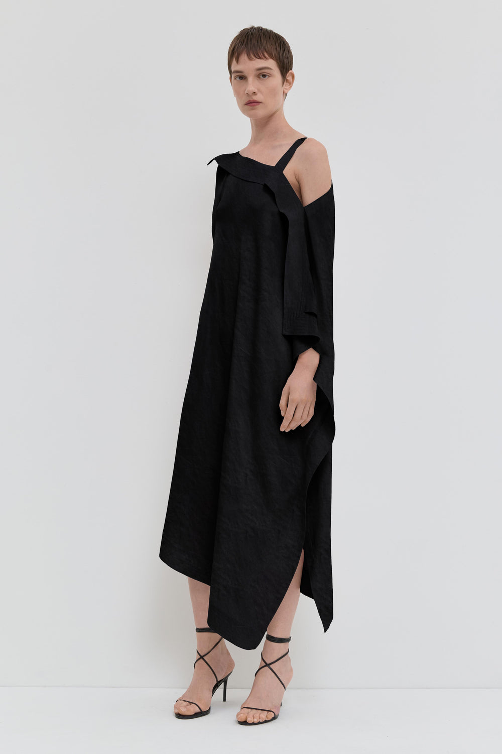 Black asymmetrical maxi dress in crushed viscose with open shoulder detail