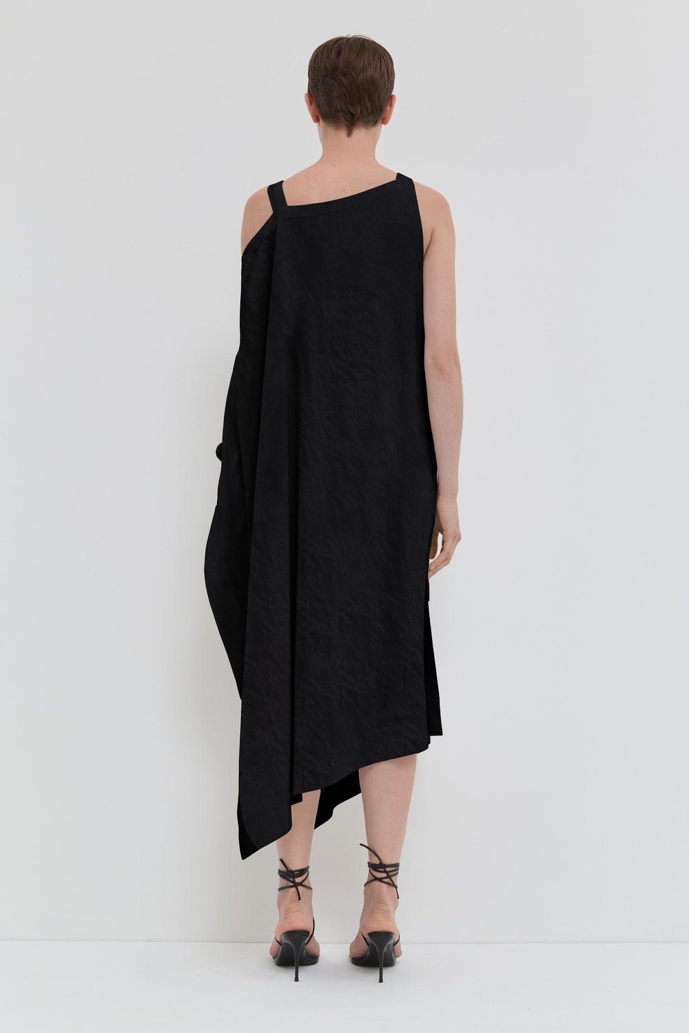Black asymmetrical maxi dress in crushed viscose with open shoulder detail