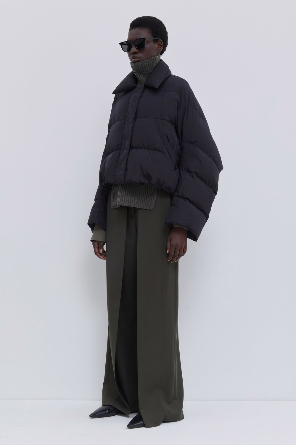 Side view of the Jani black cropped puffer jacket.