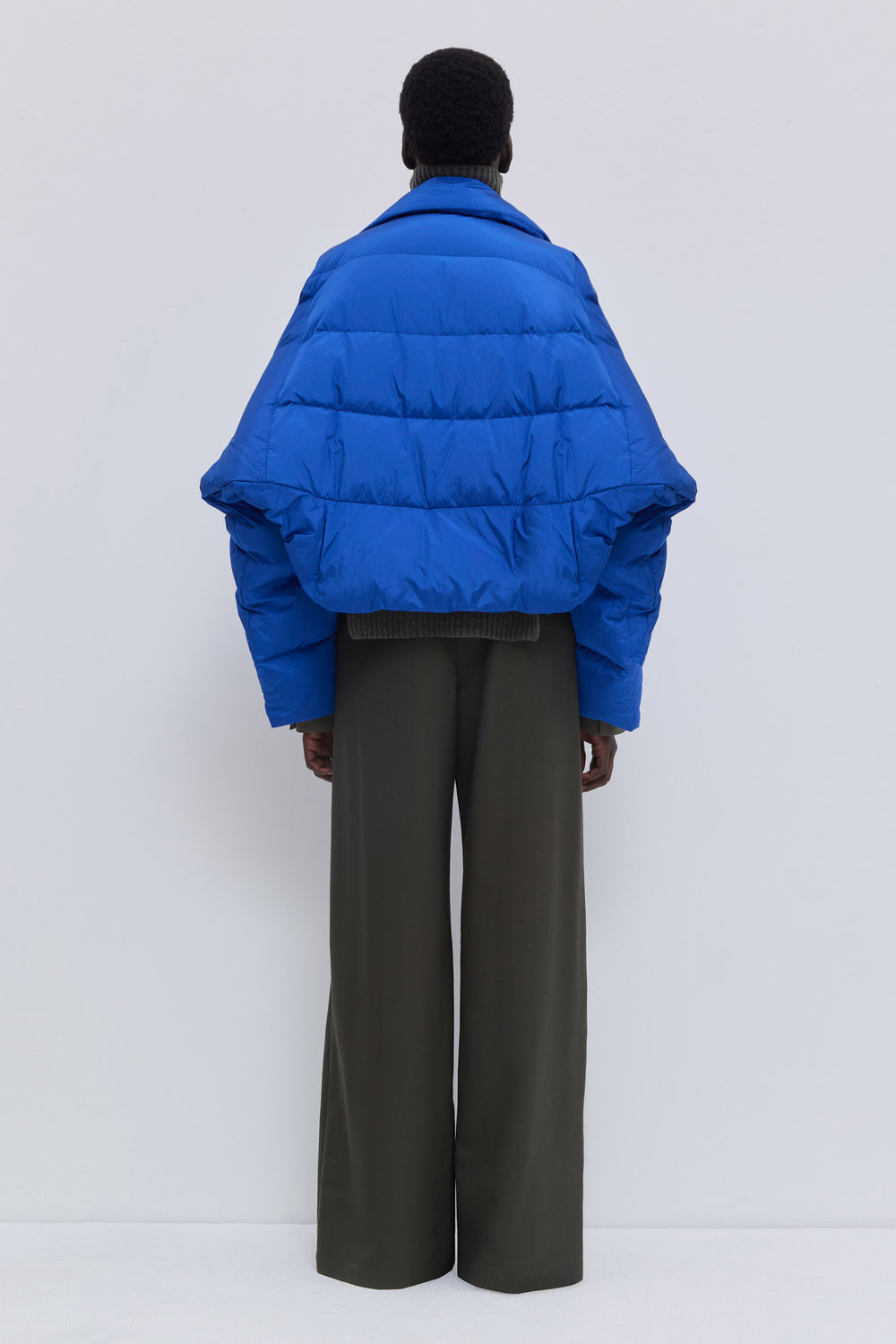 Side view of the Jani cobalt cropped puffer jacket.