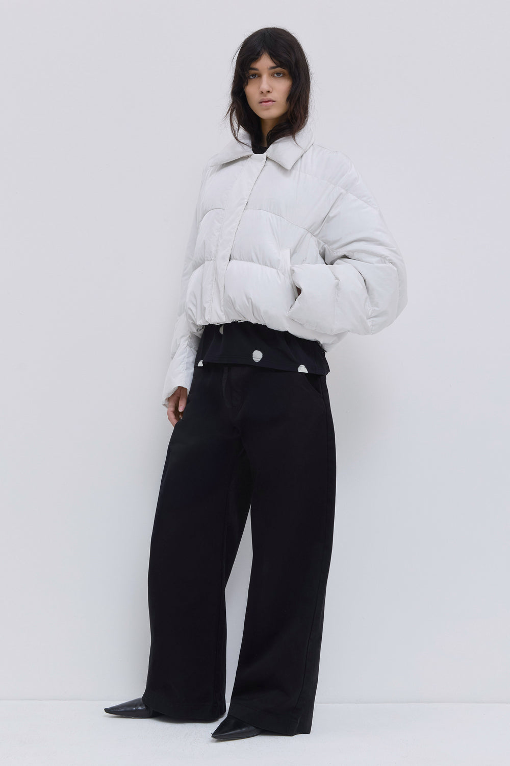 Side view of the Jani off white cropped puffer jacket.