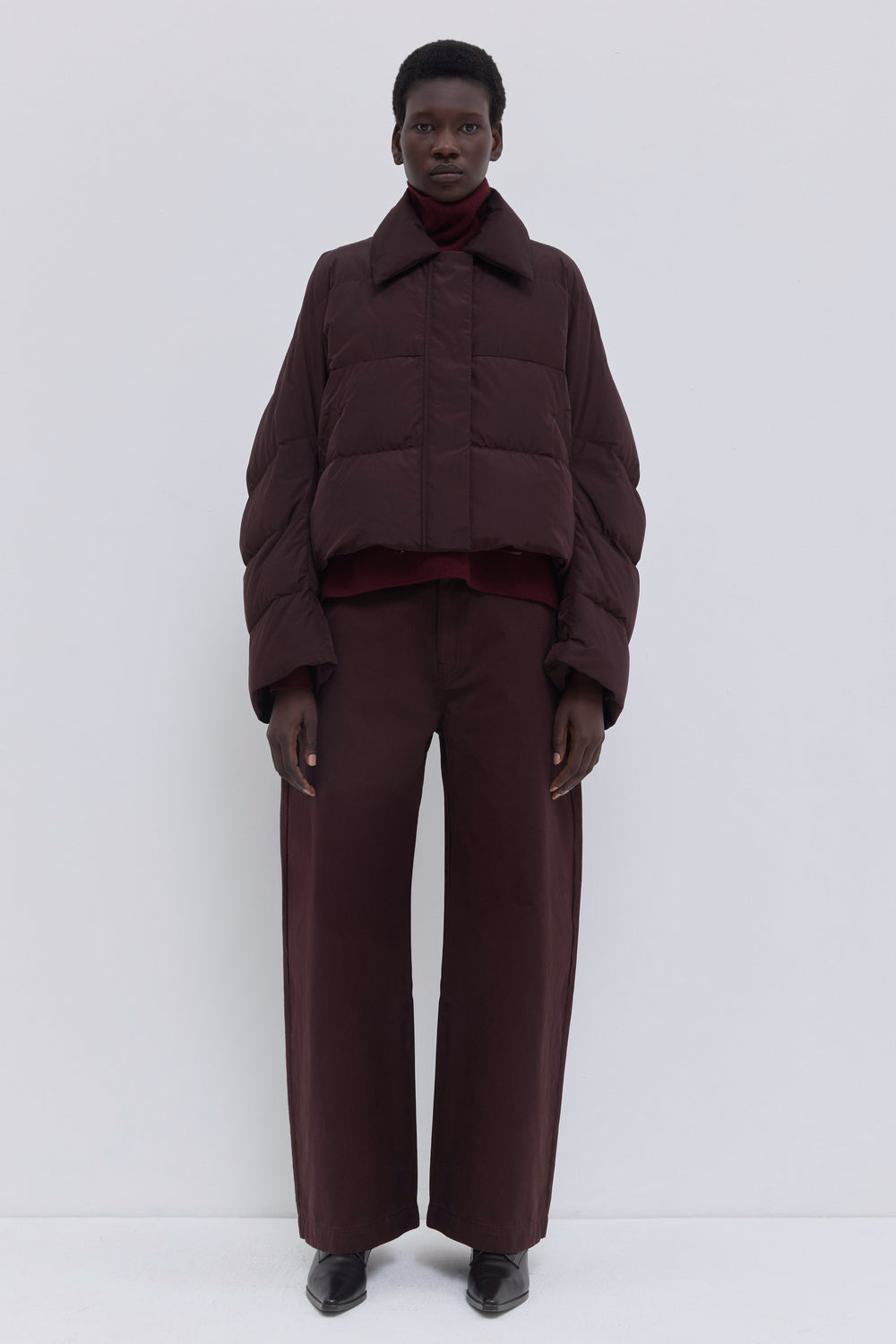Side view of the Jani plum cropped puffer jacket.