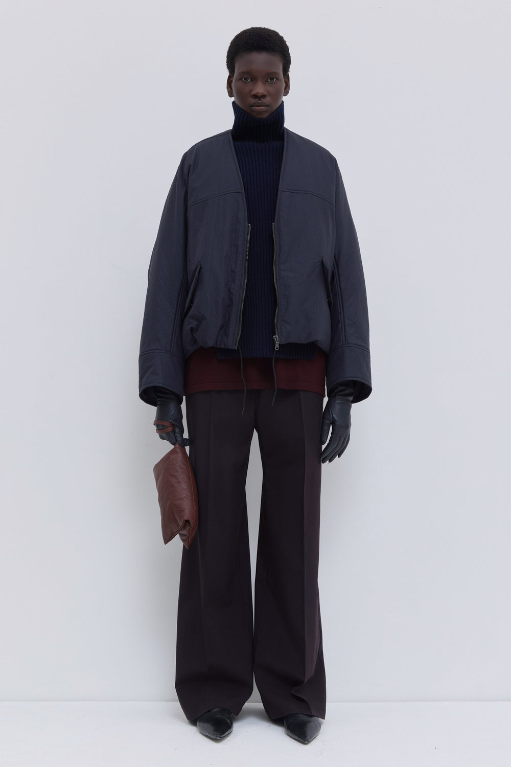 Jelana padded V-neck jacket in navy oil water-repellent fabric with sculptural sleeves and relaxed fit.