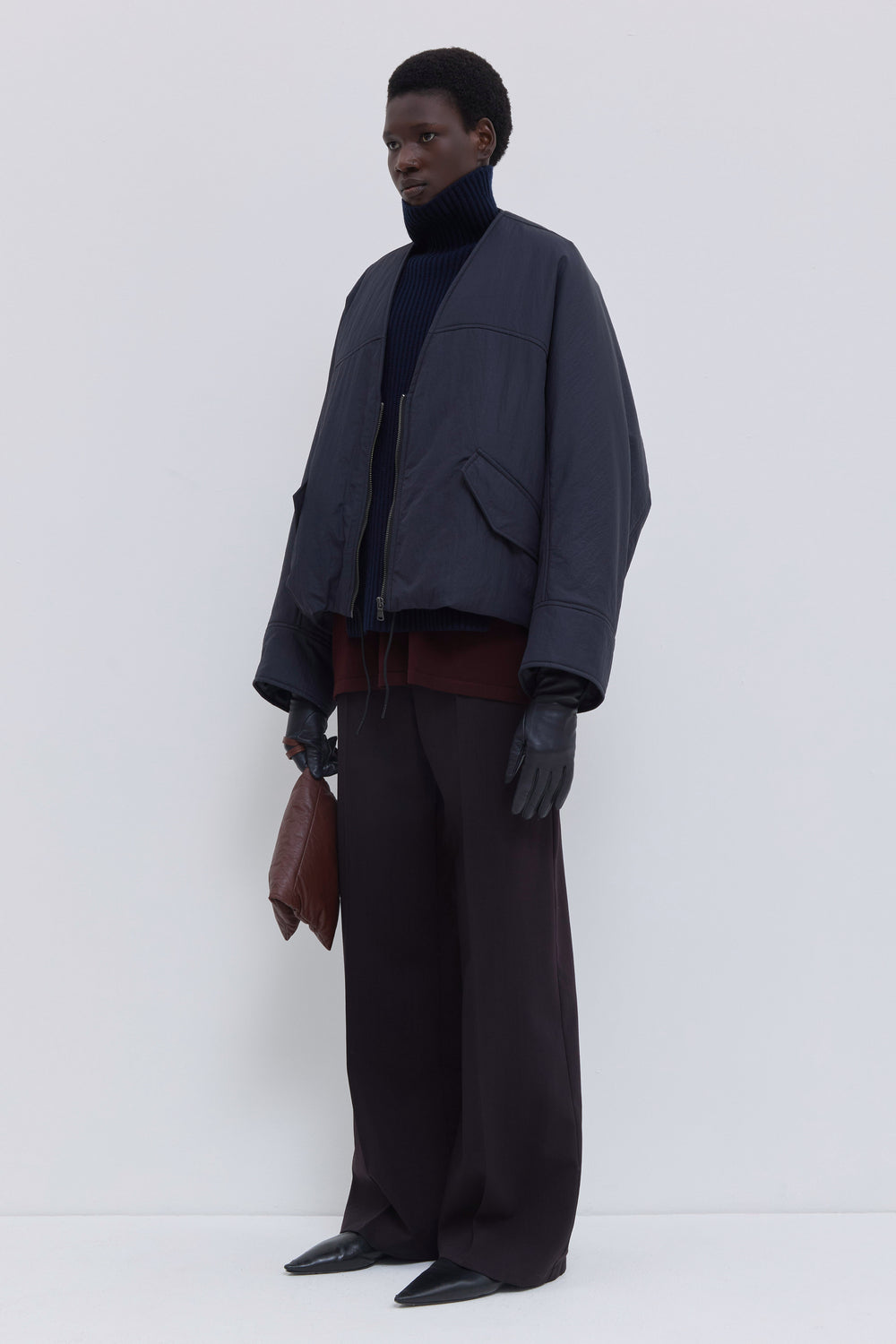 Front view of the Jelana navy oil padded jacket with zip closure, flap pockets and adjustable drawcord hem