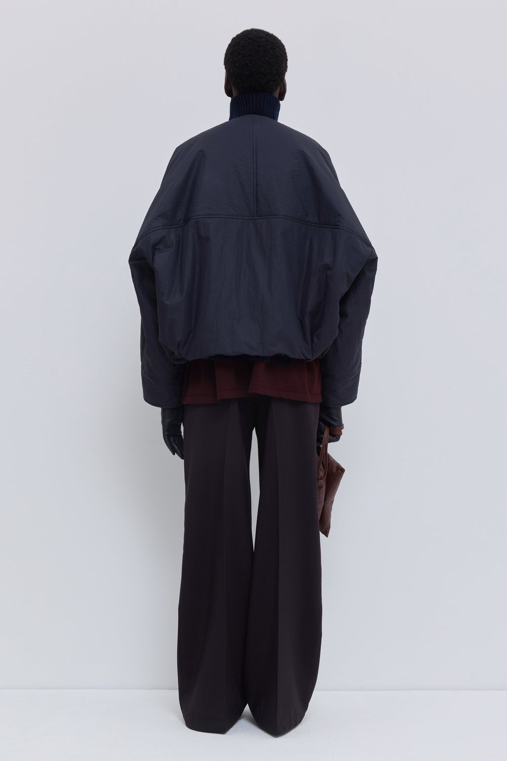 Navy oil Jelana V-neck padded jacket with subtle sheen, front zipper and adjustable hem detail.