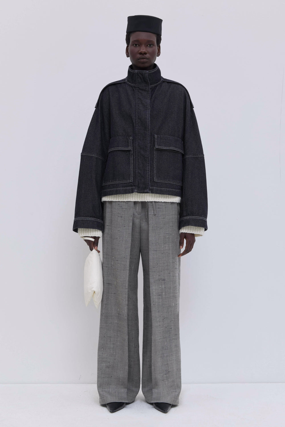 Raw dark denim cropped jacket with oversized sleeves and stand collar.