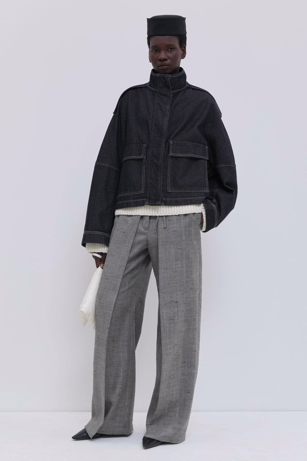 Women’s cropped raw denim jacket with patch pockets and contrast stitching.