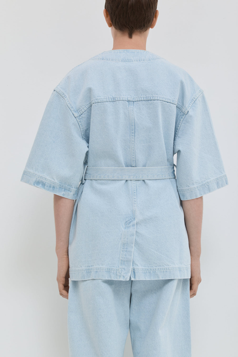 Light blue denim jacket with short kimono sleeves and relaxed fit back view