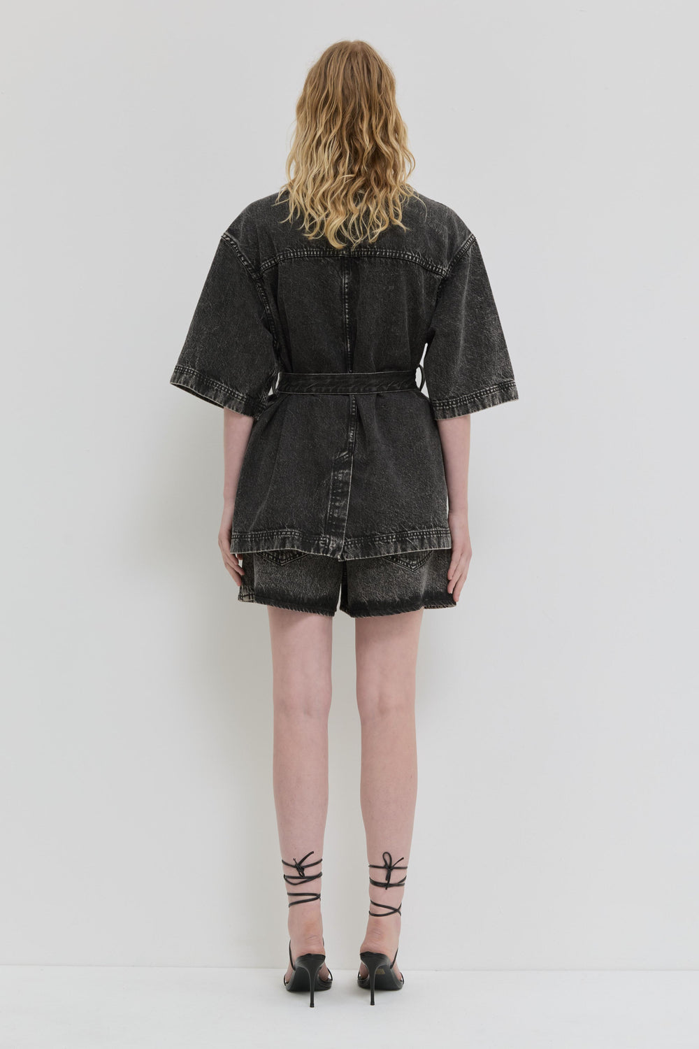 Dark denim jacket with short kimono sleeves and belt detail back view