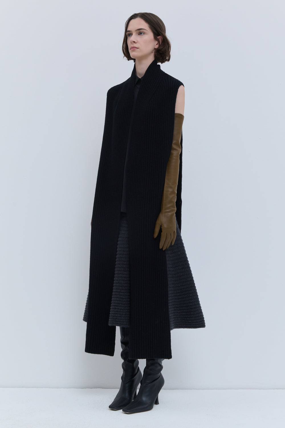 Christian Wijnants Kadija black ribbed scarf worn over a black outfit