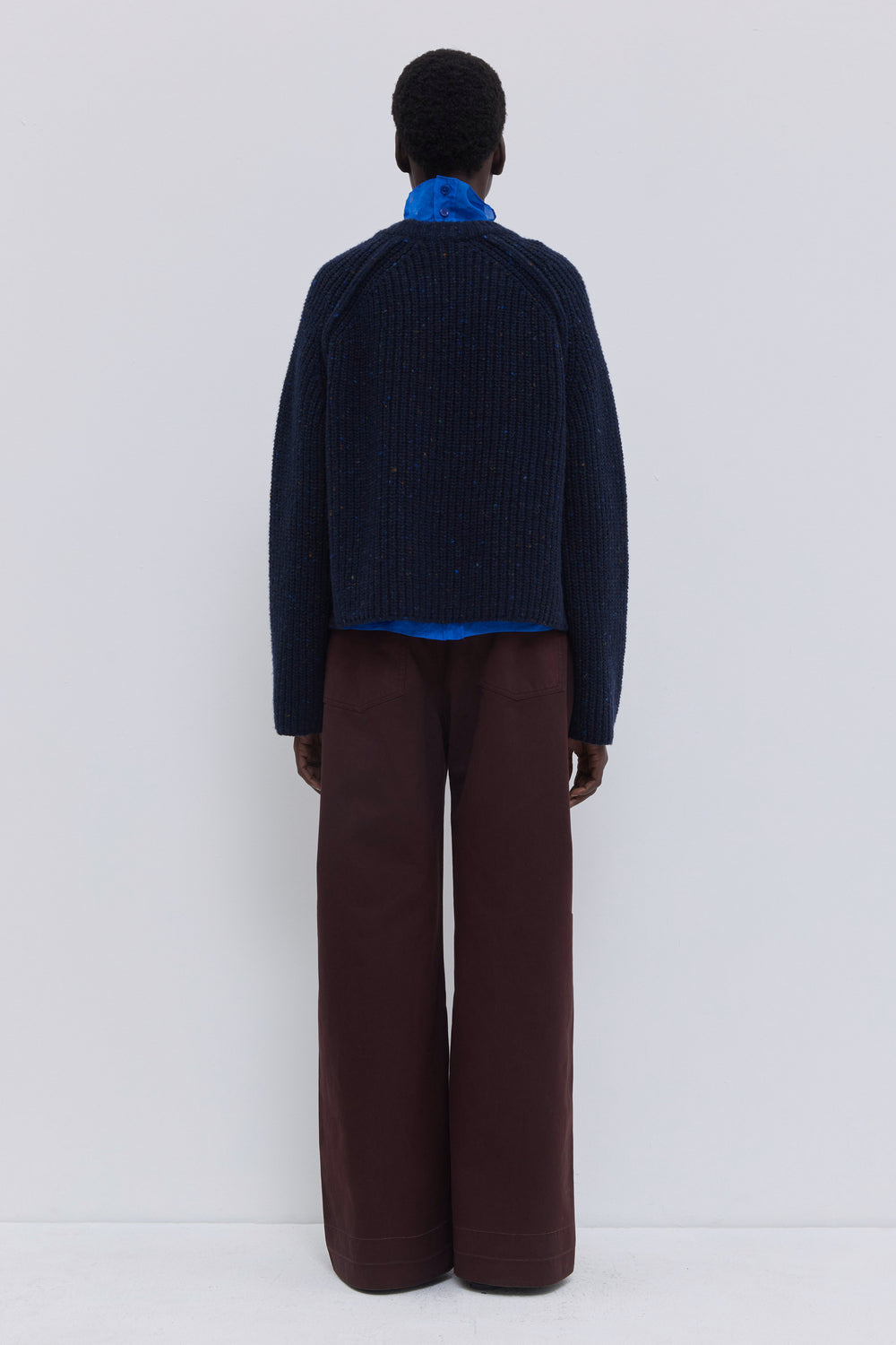 Side view of a relaxed-fit ribbed cashmere blend sweater with raglan sleeves.