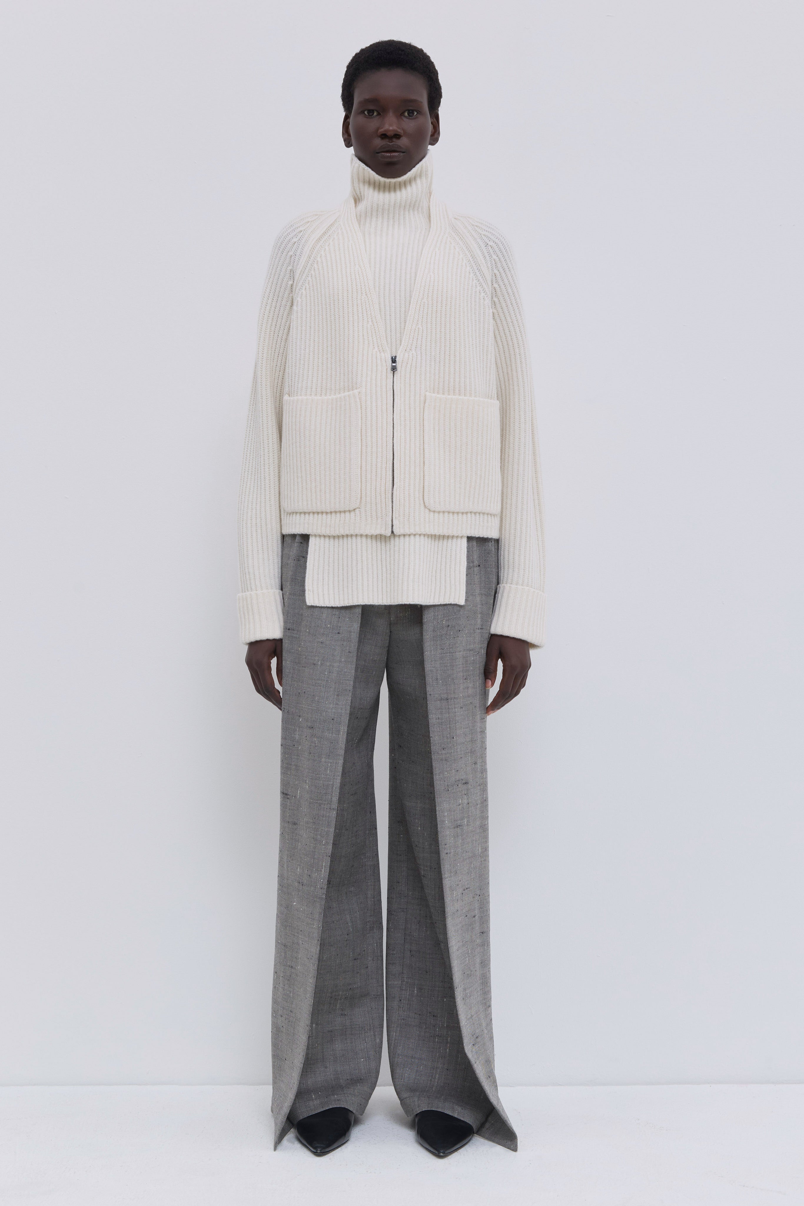 Cream ribbed V-neck cardigan in an Italian cashmere blend with patch pockets.