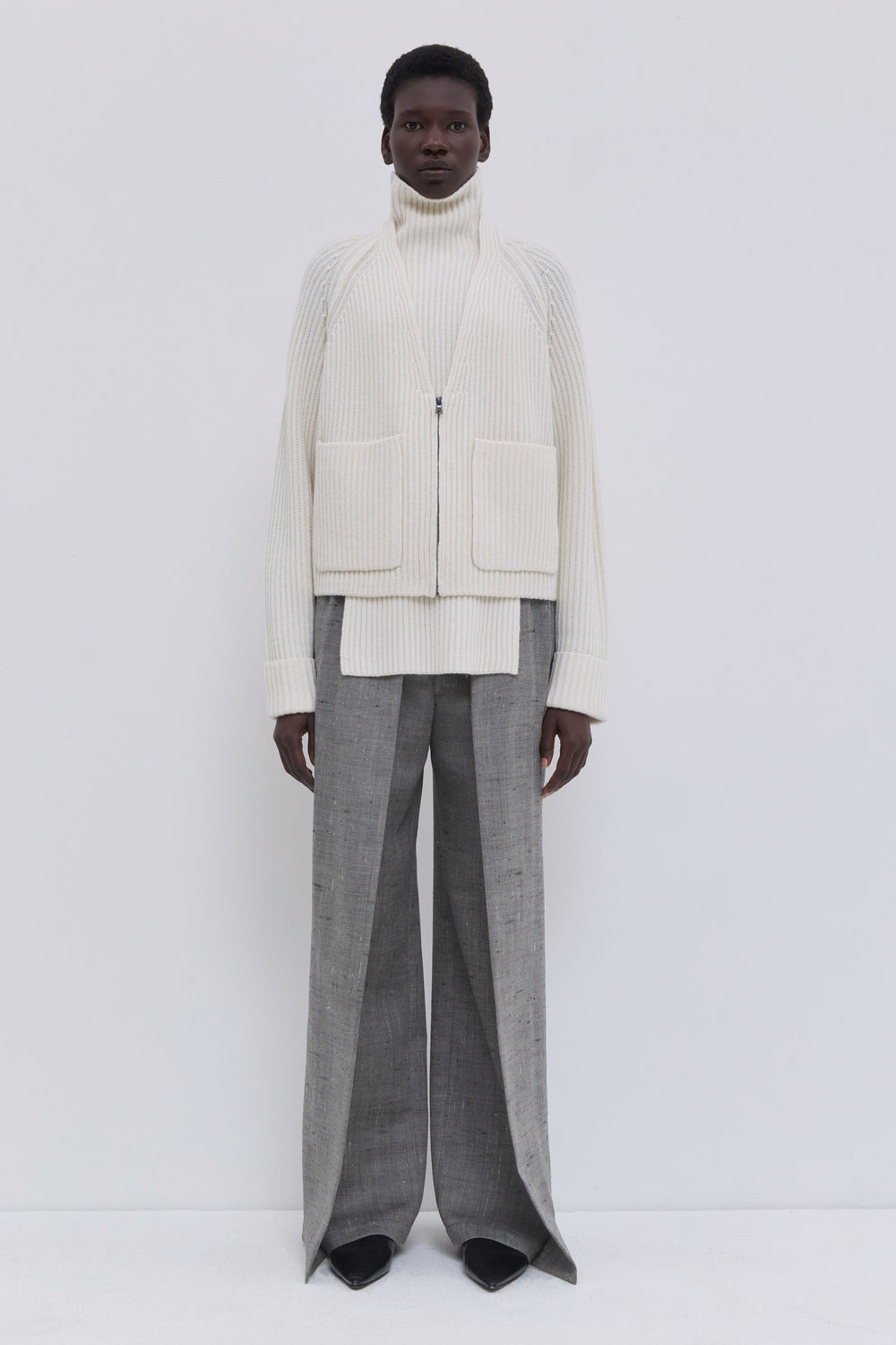 Cream ribbed V-neck cardigan in an Italian cashmere blend with patch pockets.
