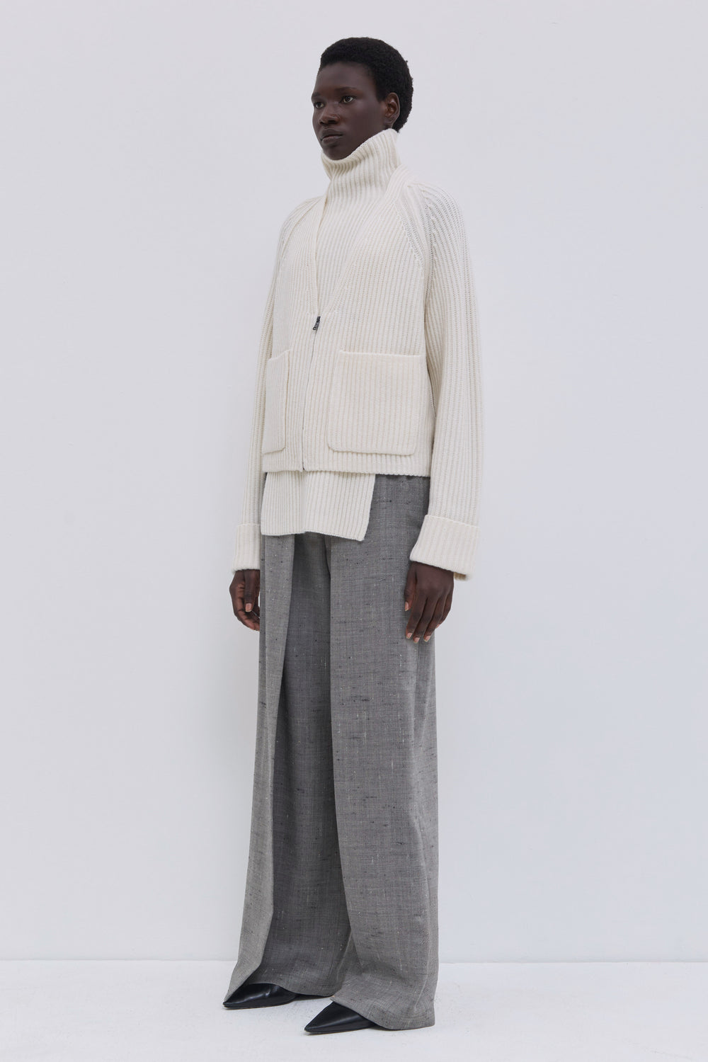 Women’s cream zip-front ribbed cardigan with a relaxed fit.