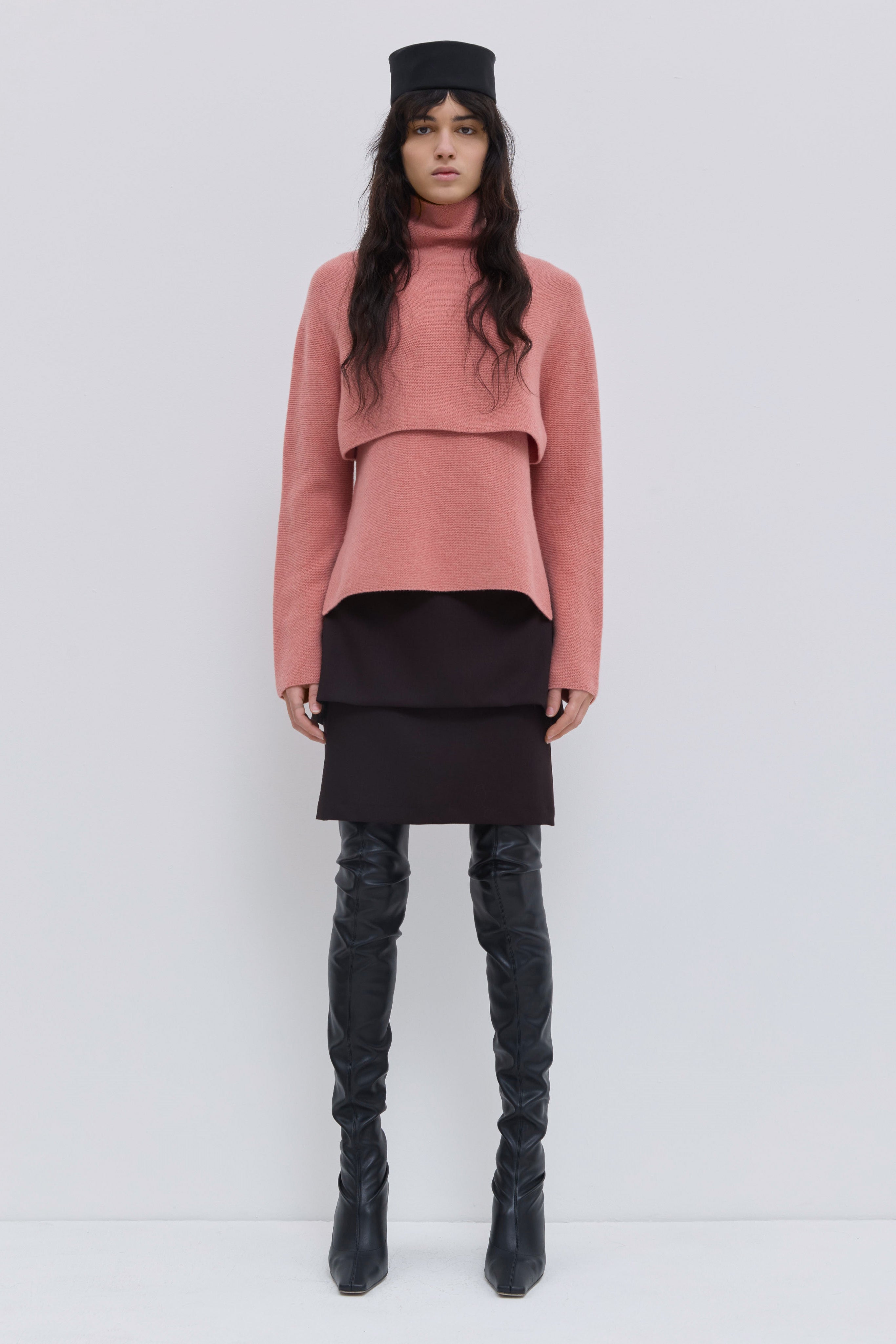 Coral cropped turtleneck sweater in super fine wool layered over matching knit top