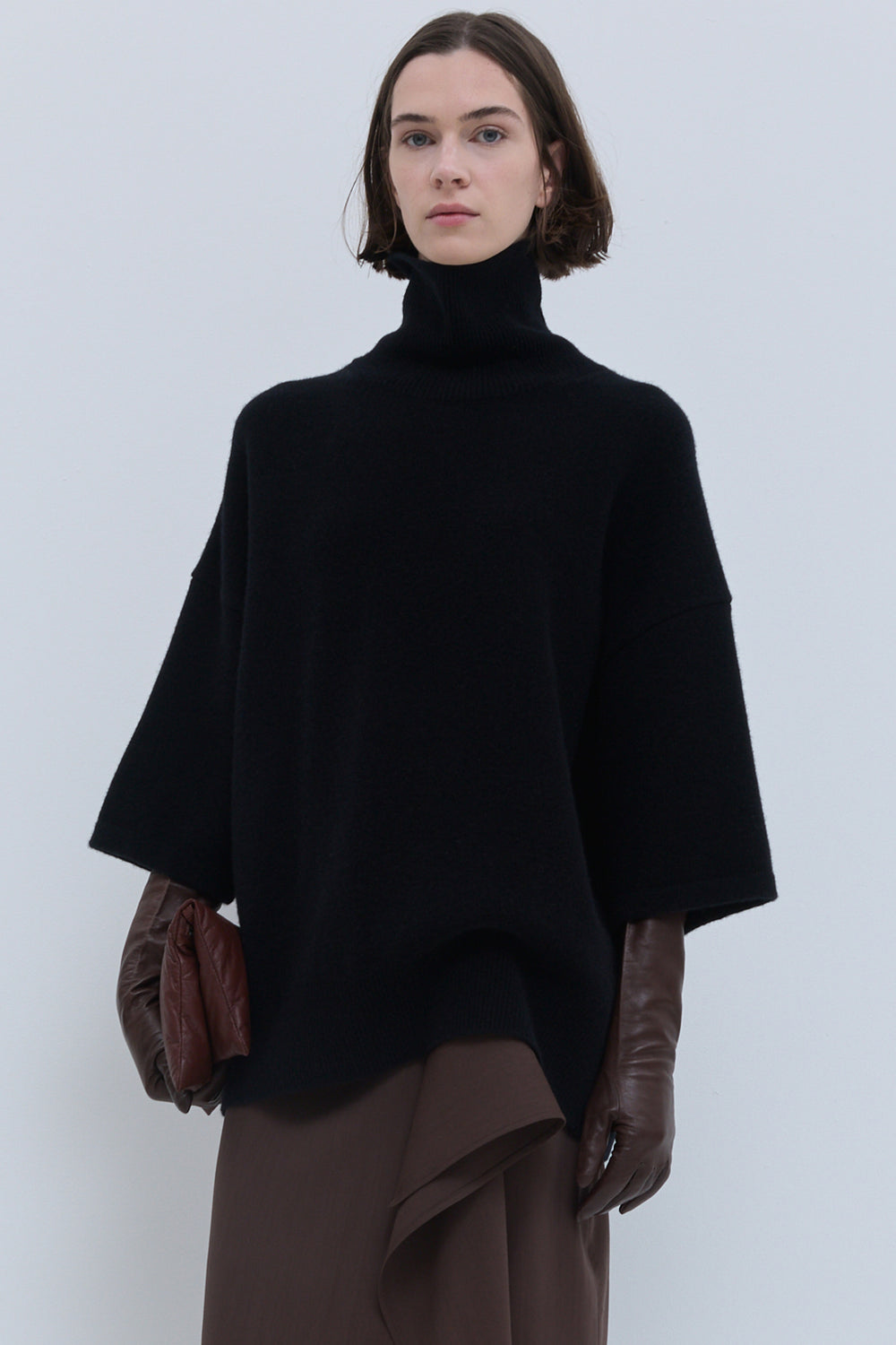 Black oversized knit top with high turtleneck