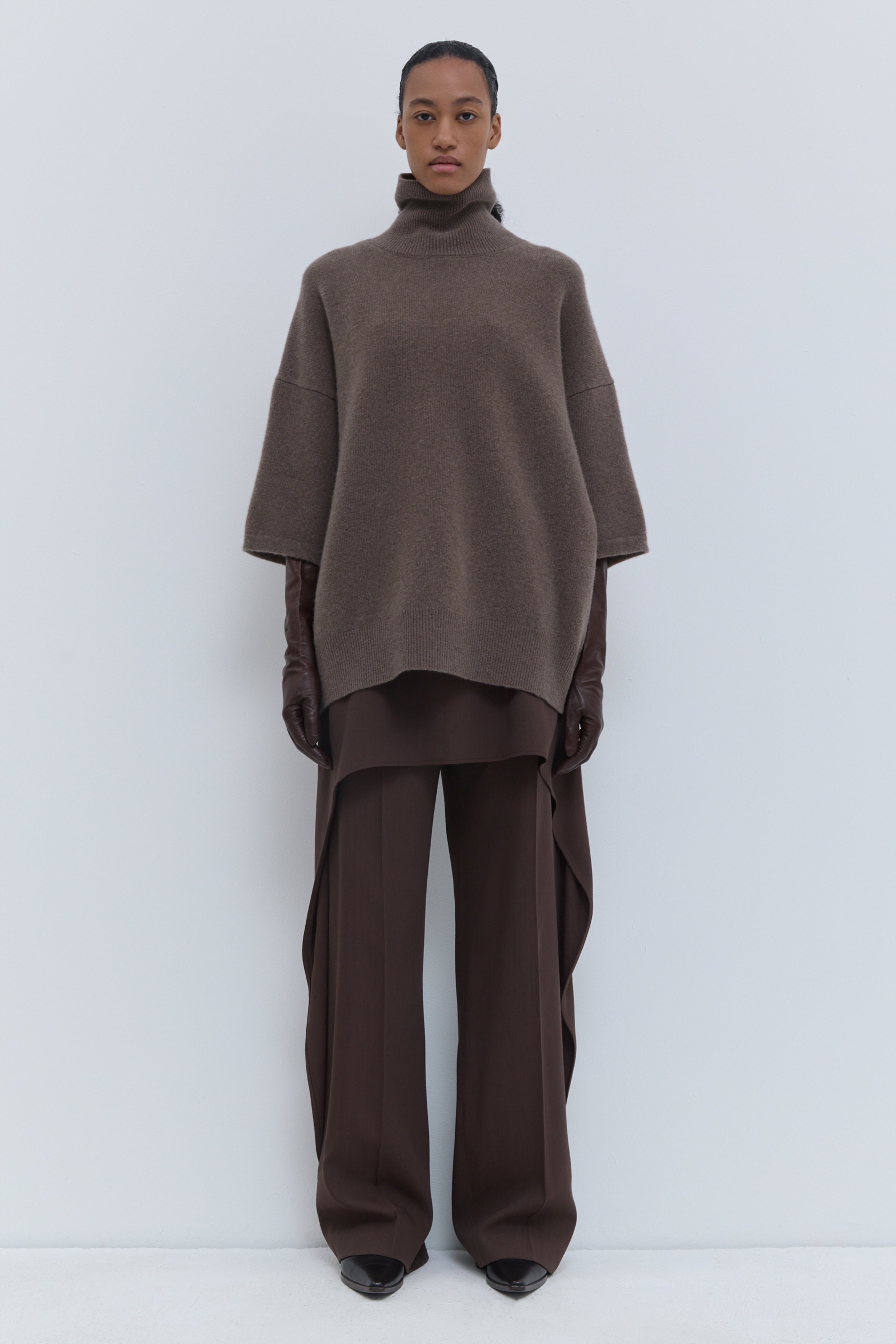 Brown melange oversized turtleneck knit with wide sleeves and relaxed silhouette