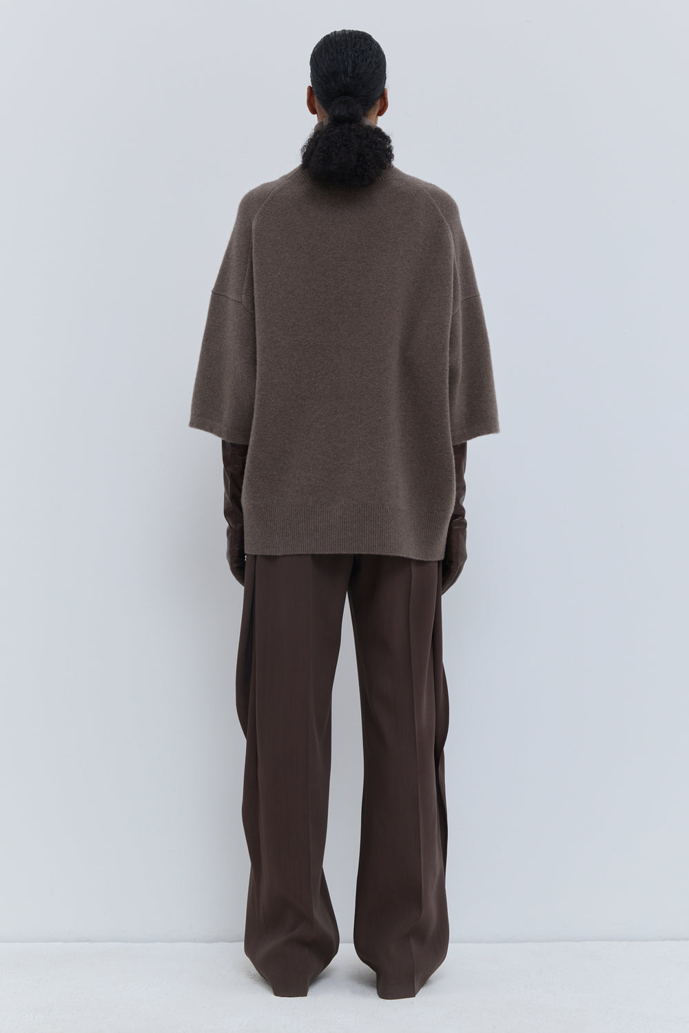Back view of brown melange oversized turtleneck knit with wide three-quarter sleeves