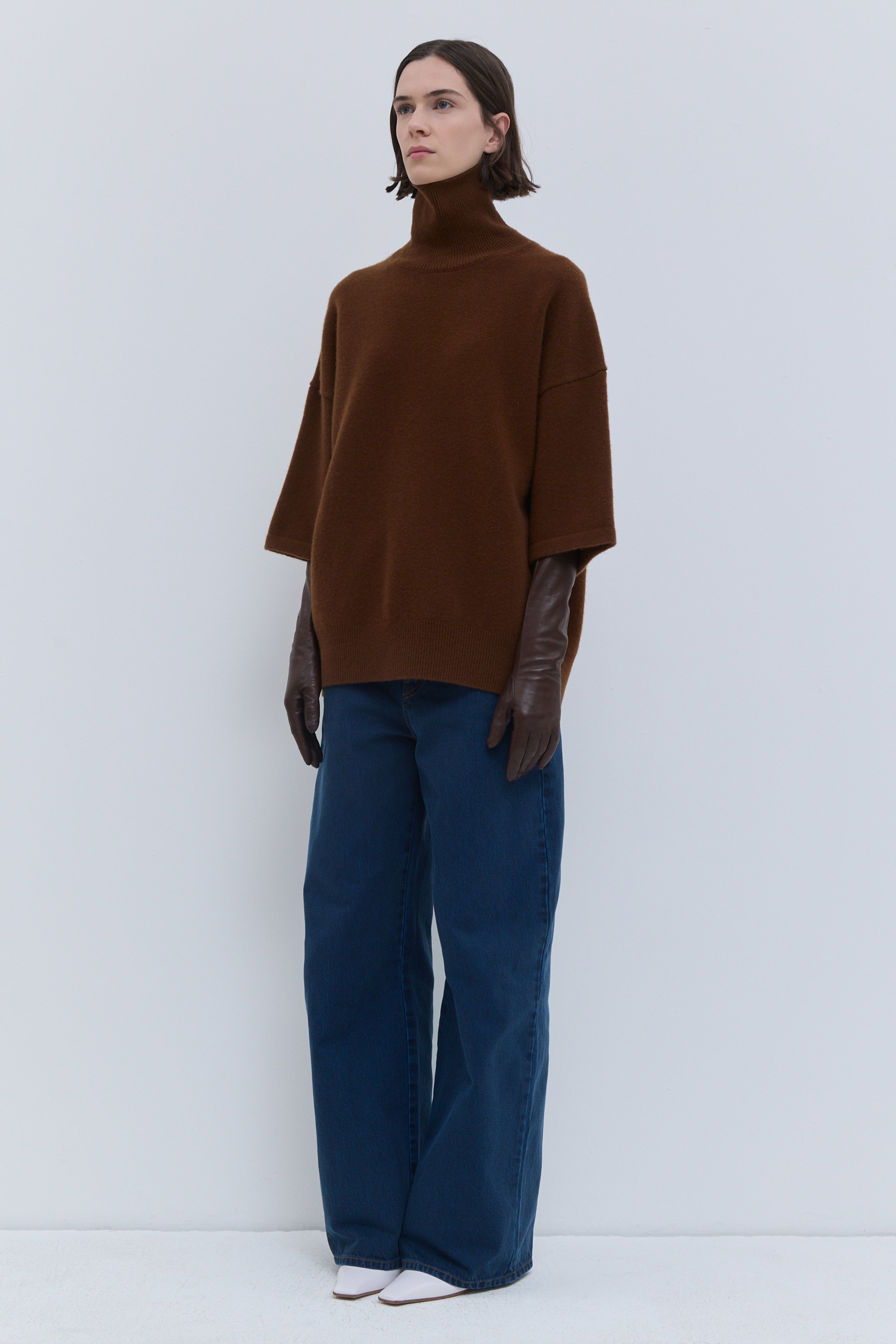 Rust oversized turtleneck knit with wide sleeves and relaxed silhouette
