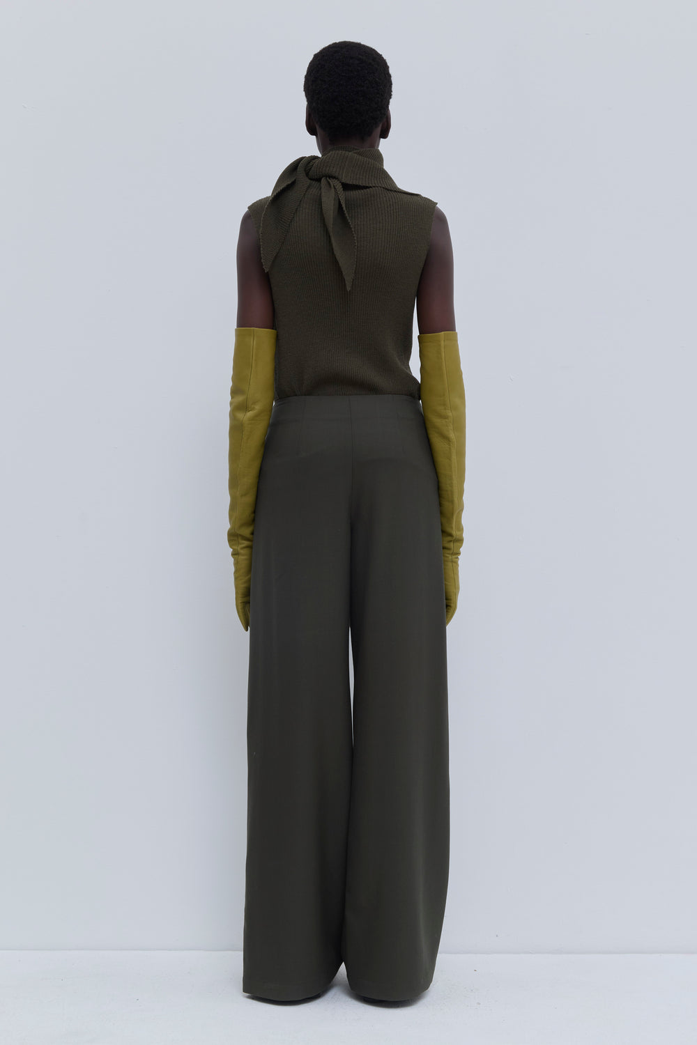 Back view of the Paire wide-leg trousers in Deep Forest with deep pleats and adjustable waist cord.