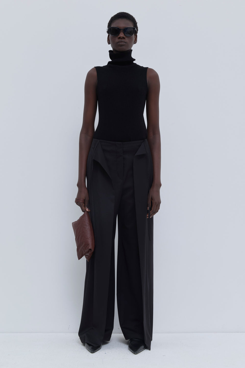 Front view of the Paire wide-leg trousers in black with deep pleats and adjustable waist cord.