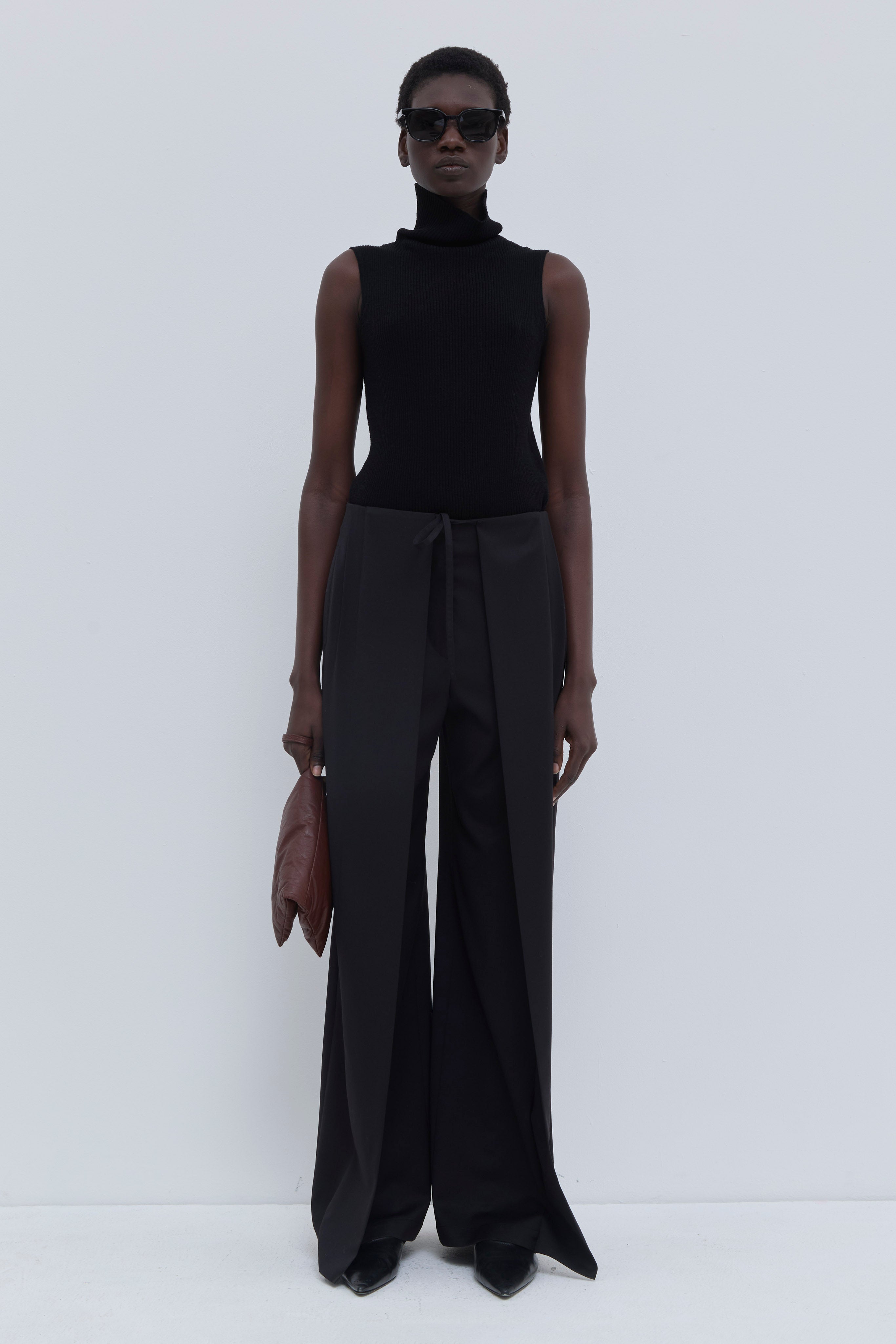 Front view of the Paire wide-leg trousers in black with a fluid wide-leg silhouette.