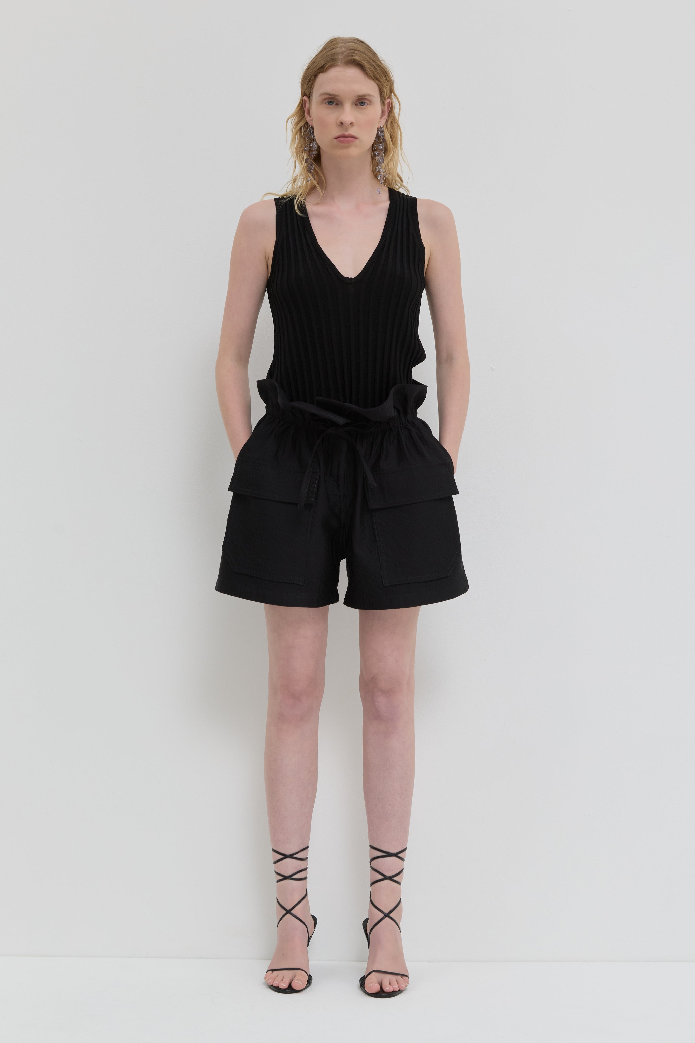 Black quilted belted shorts with folded waistband and topstitching