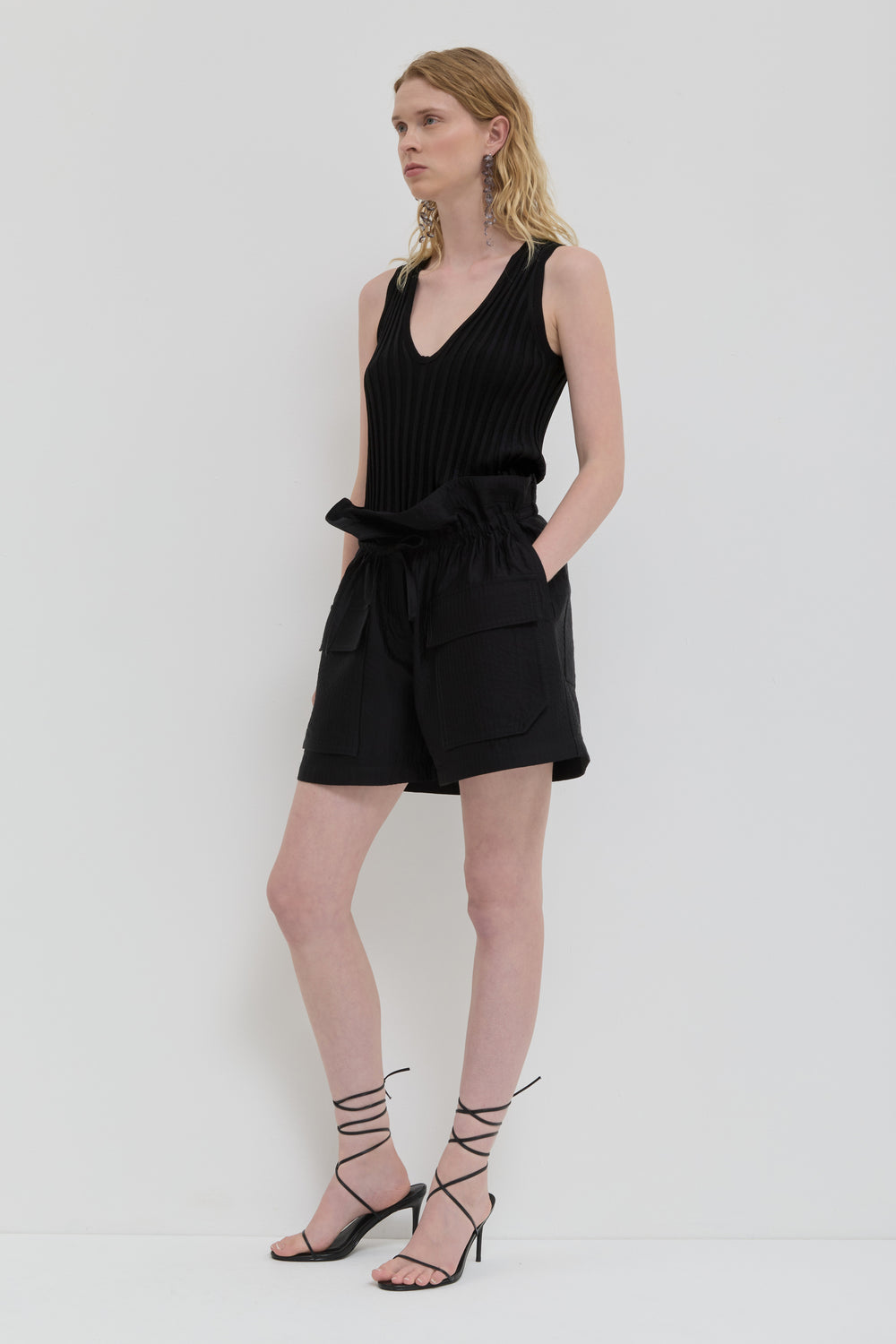 Black quilted belted shorts with folded waistband and topstitching