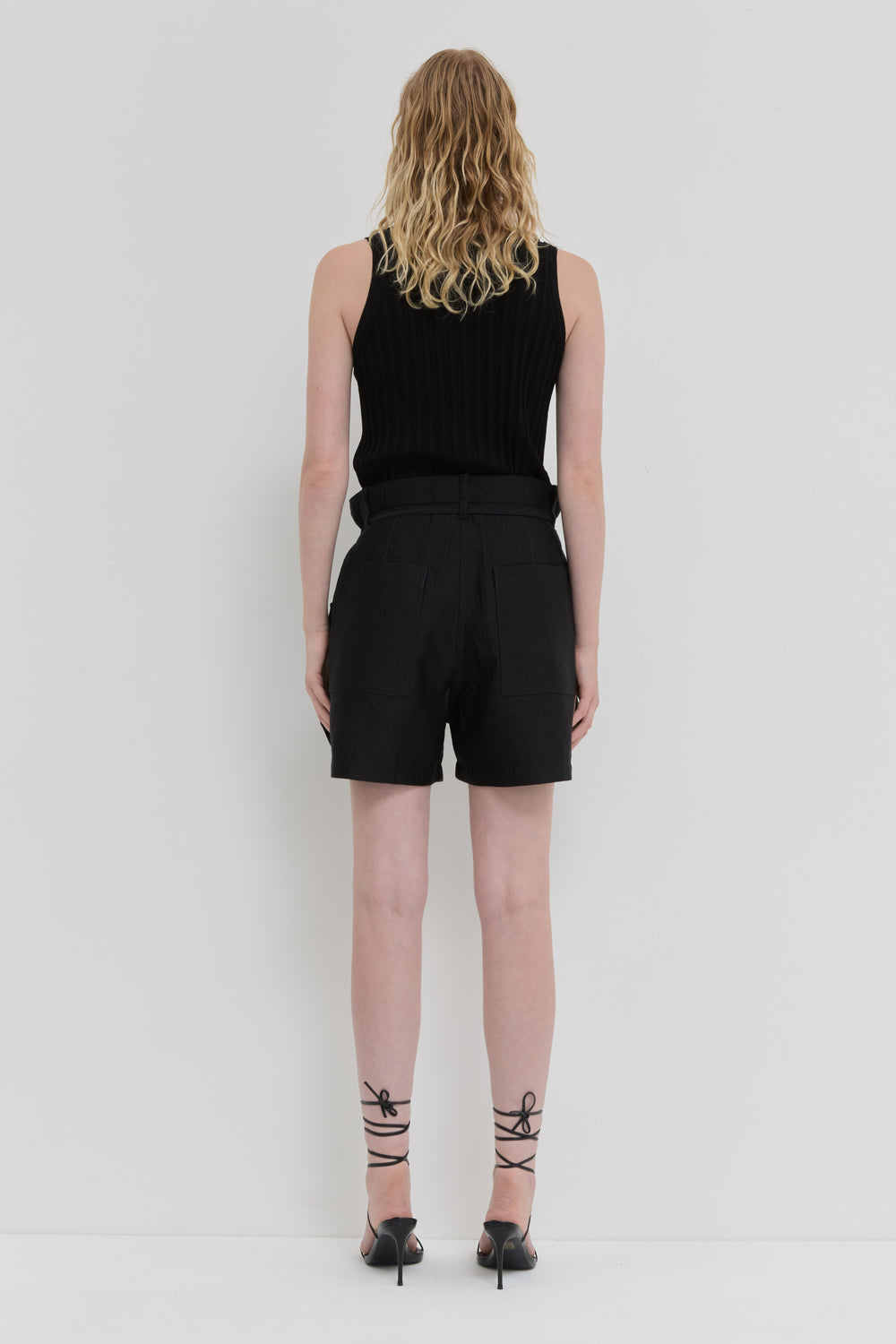 Black quilted belted shorts with folded waistband and topstitching