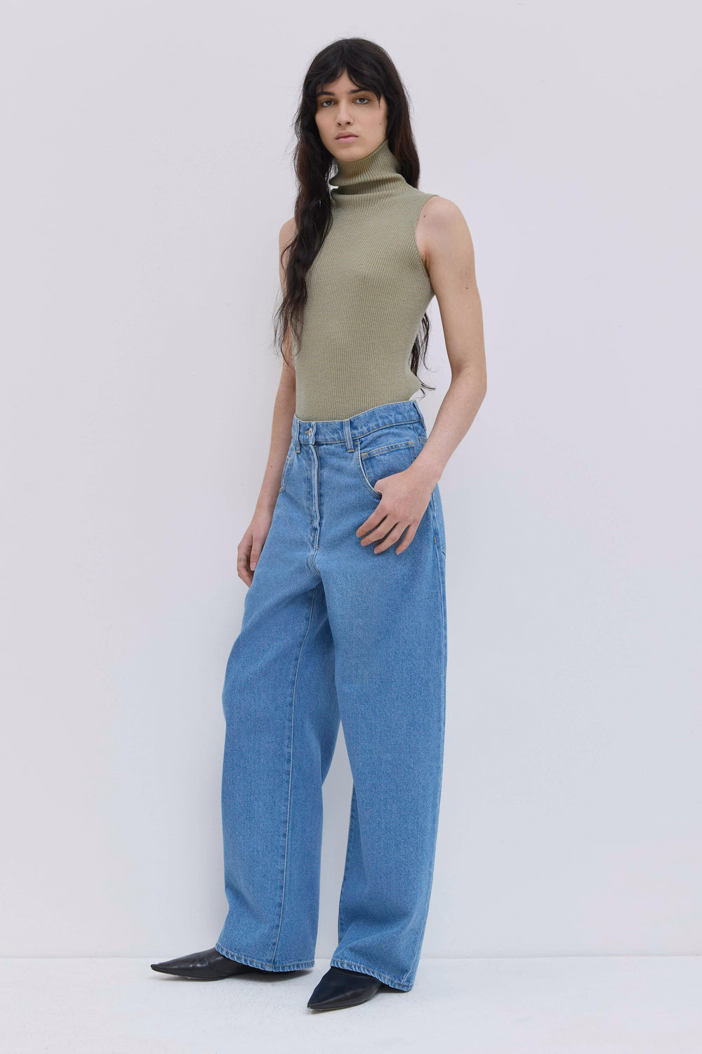 Front view of light blue wide-leg denim jeans with five-pocket construction.