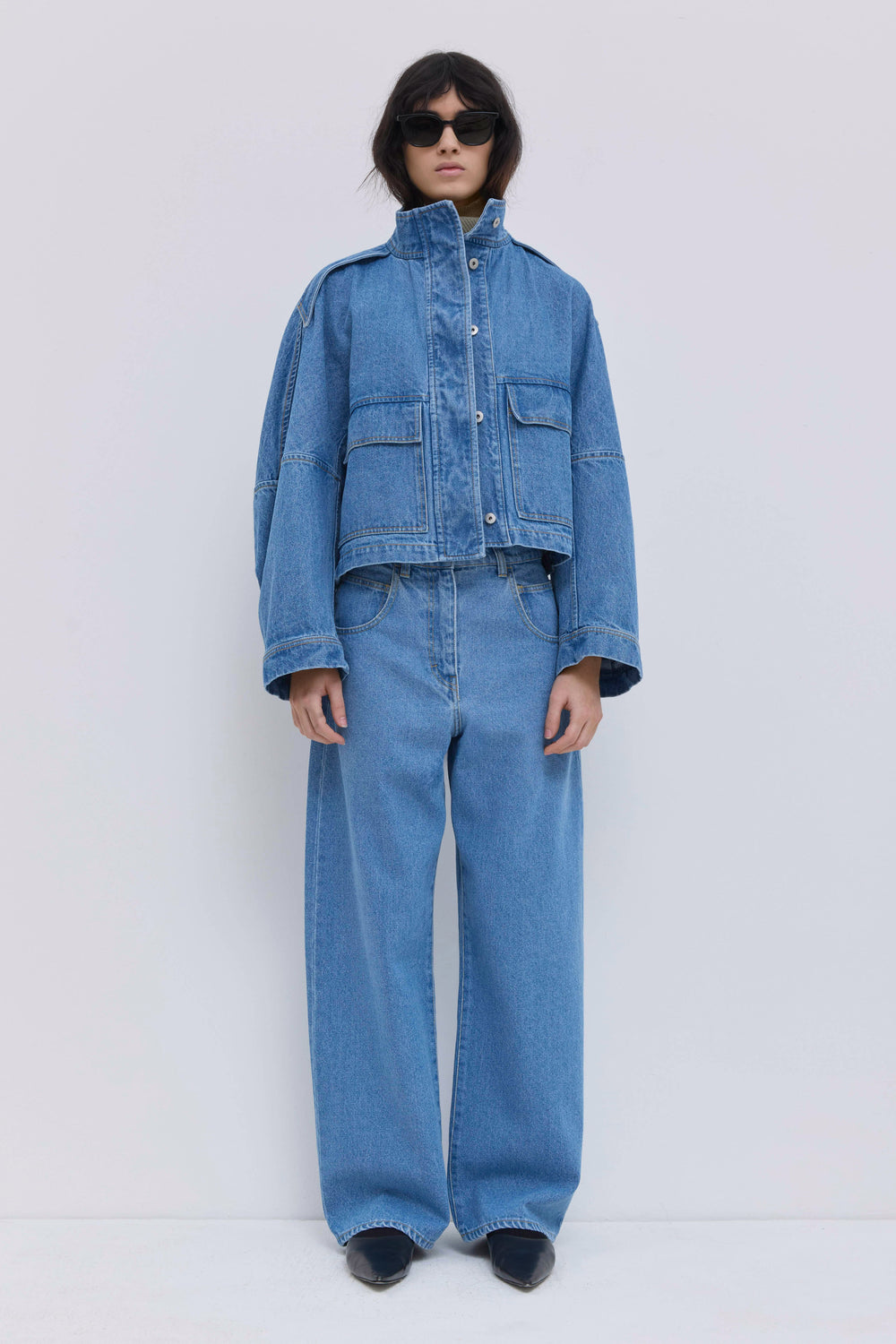 High-rise light blue denim jeans with a full-length wide-leg fit.