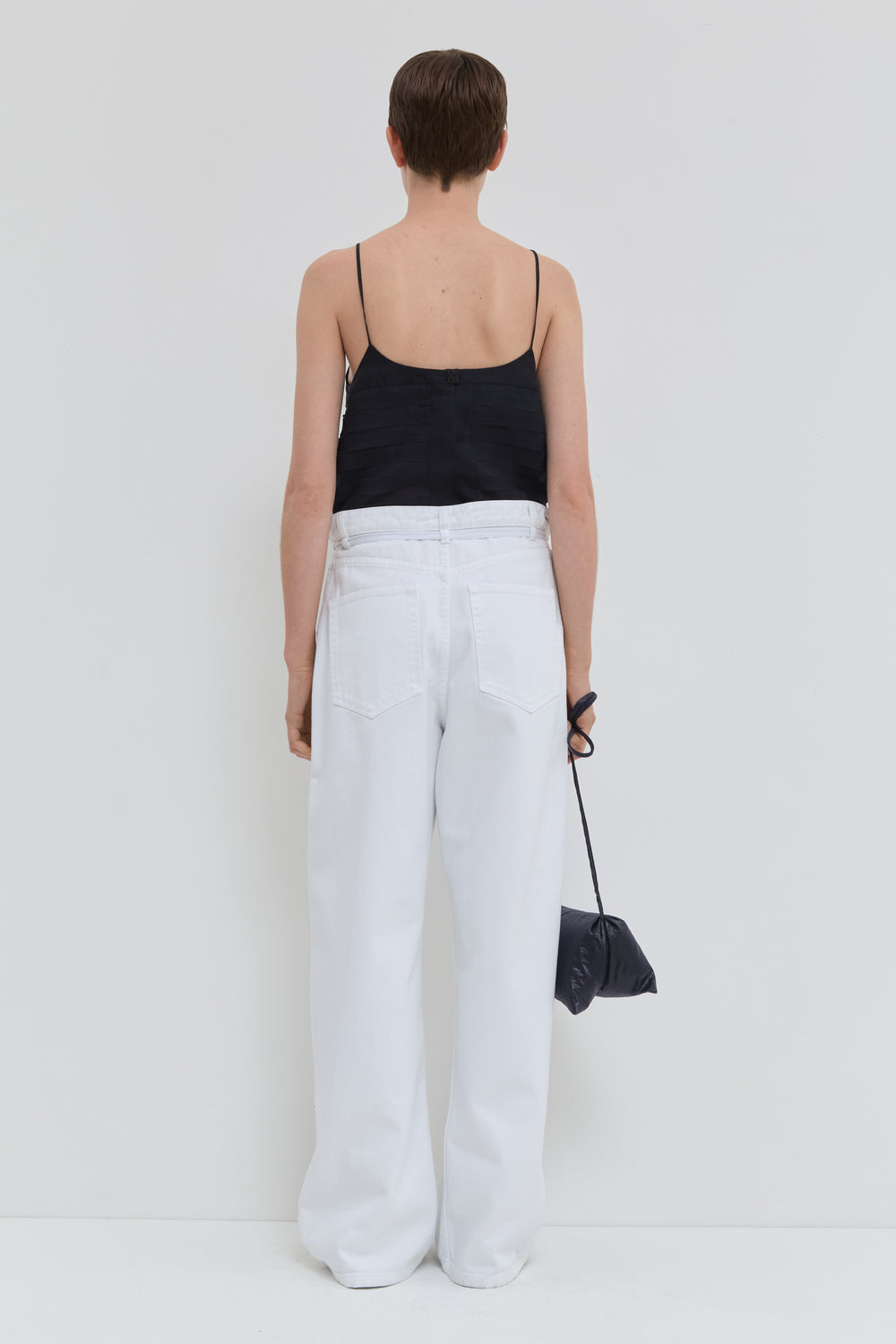 Optical white wide leg jeans with folded waistband and belt detail back view