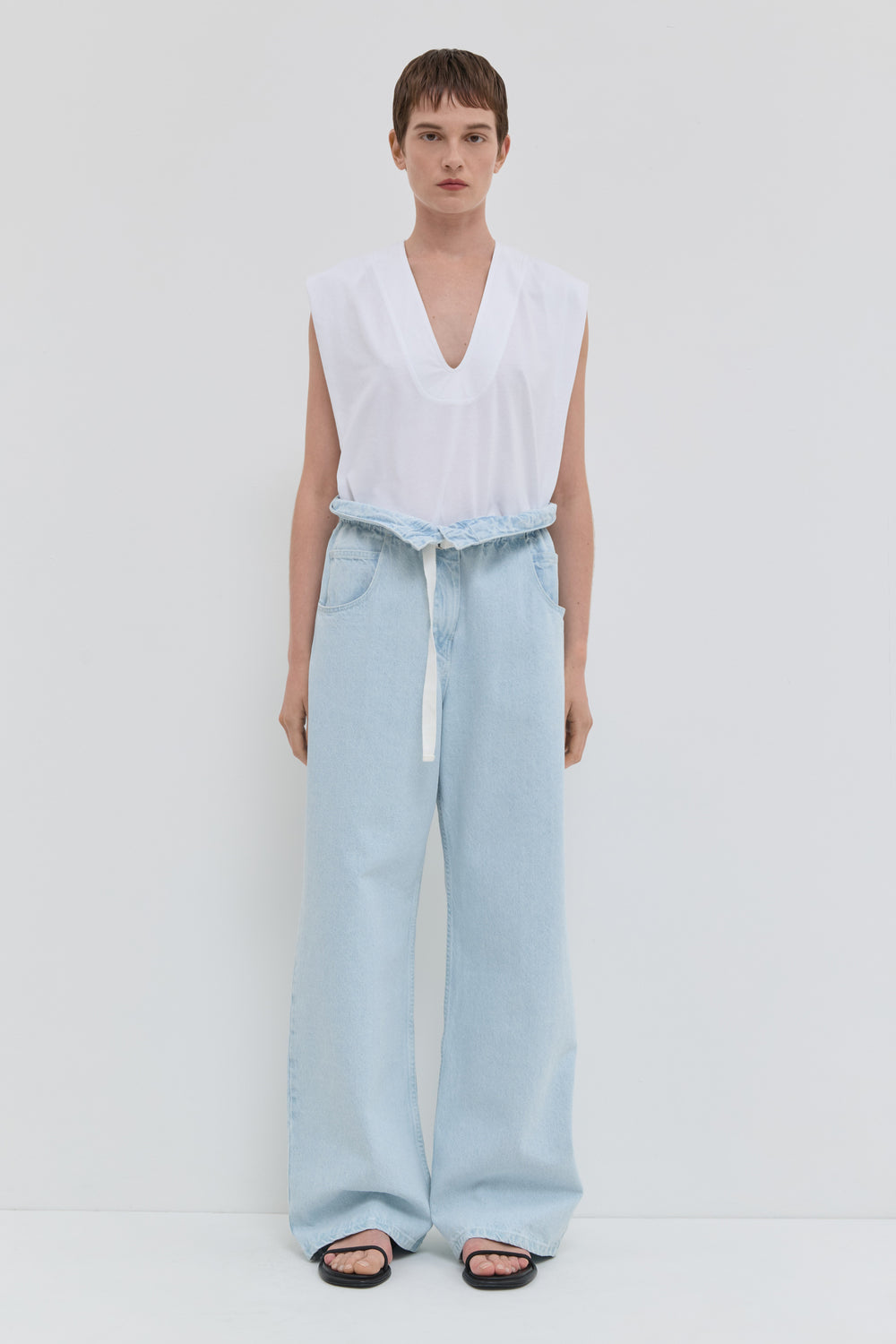 Light blue wide leg jeans with folded waistband and belt detail