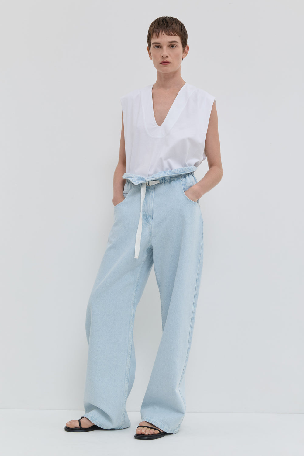 Light blue wide leg jeans with folded waistband and belt detail