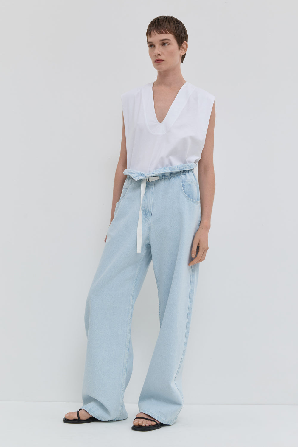 Light blue wide leg jeans with folded waistband and belt detail