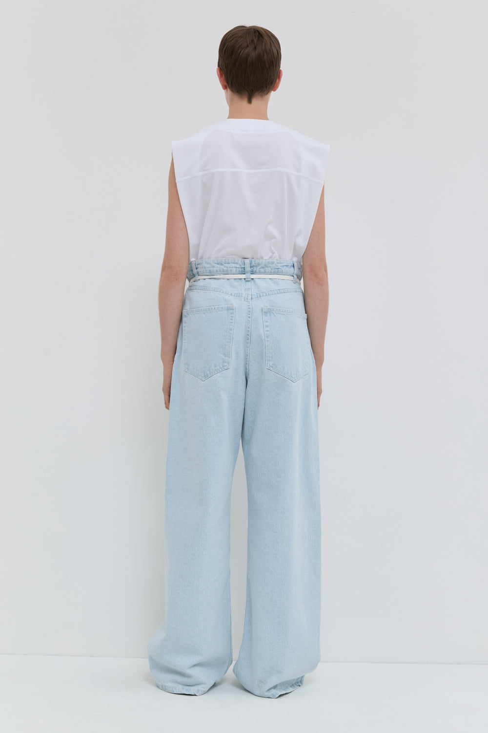 Light blue wide leg jeans with folded waistband and belt detail