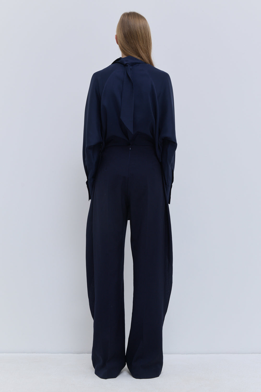 Back view of Christian Wijnants Pilba wide-leg trousers in dark navy 100% virgin wool