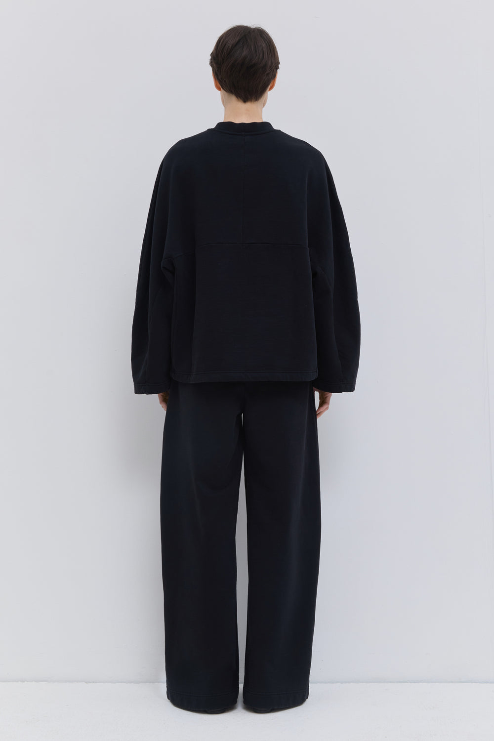 Back view of black relaxed-fit jersey sweatpants.