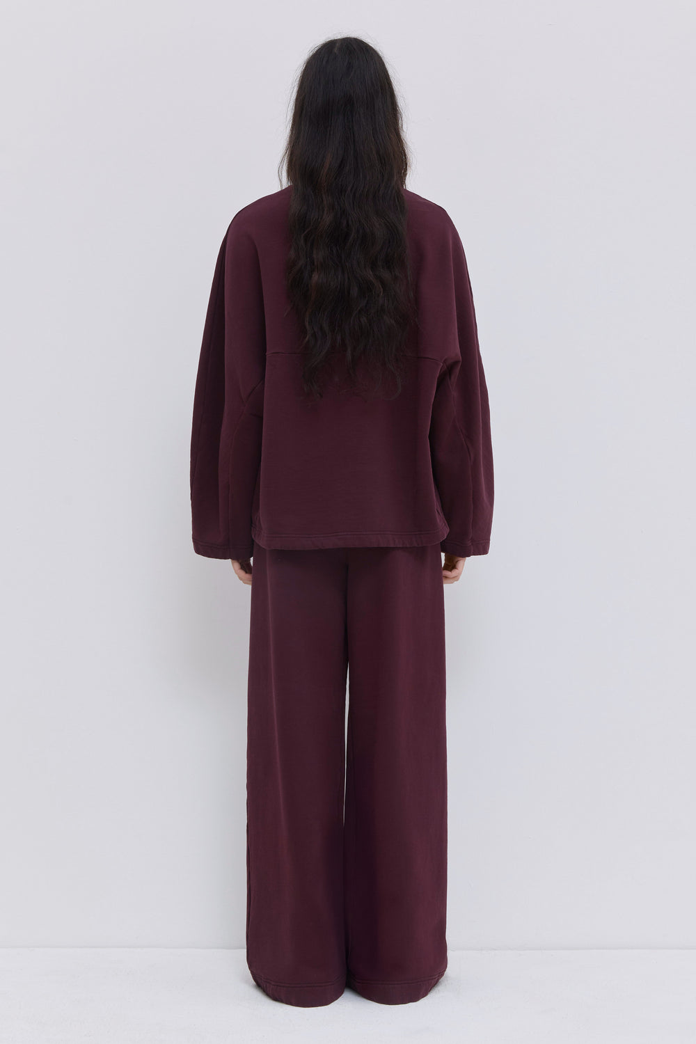Burgundy garment-dyed sweatpants styled with the matching Tahoras jersey top.