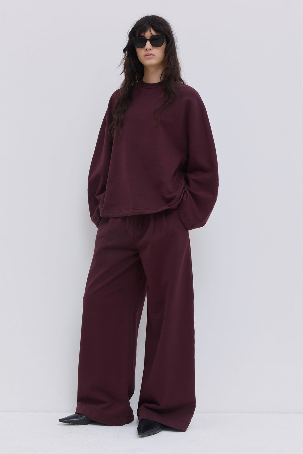 Back view of burgundy relaxed-fit jersey sweatpants.