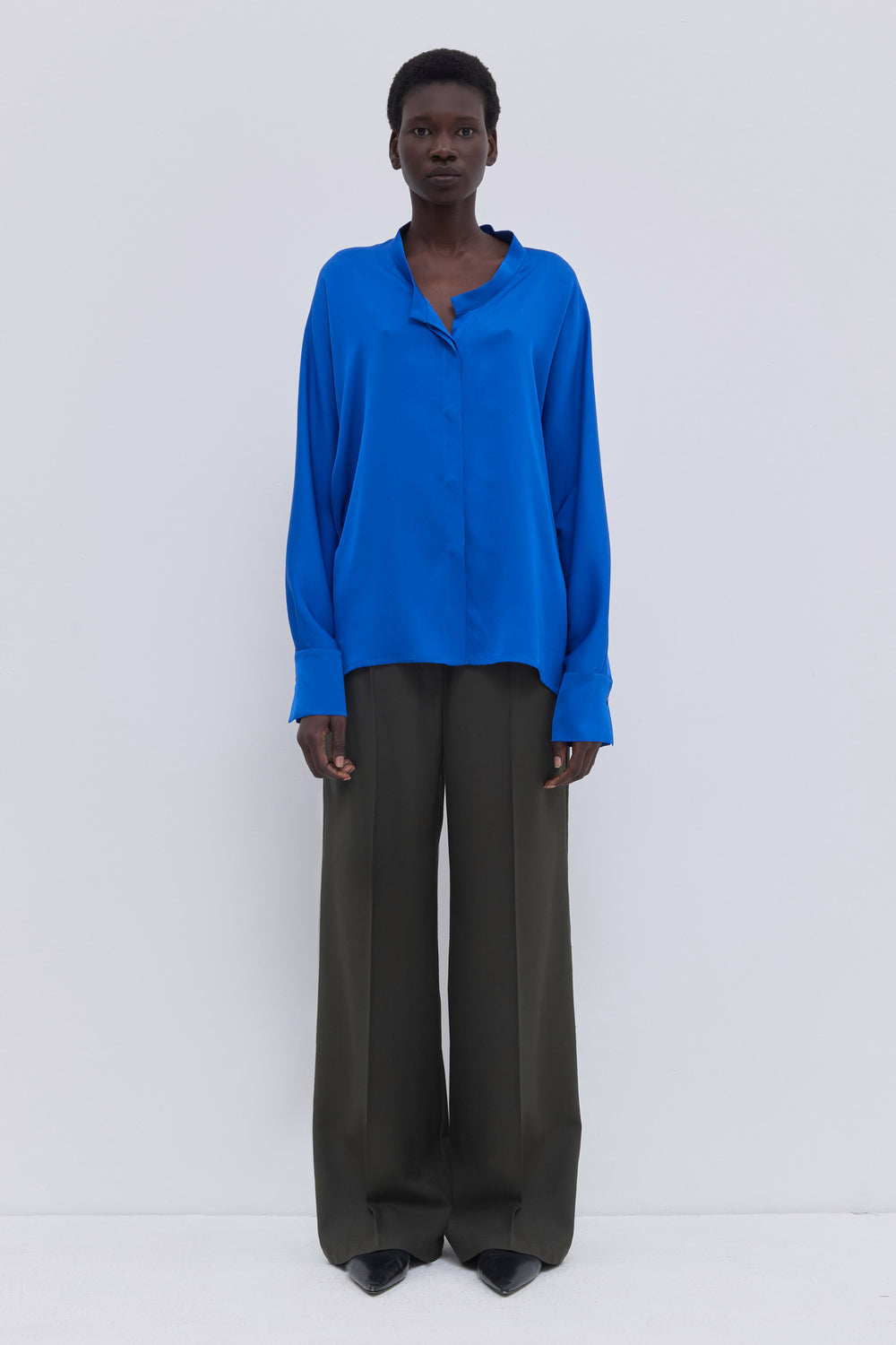 Side view of dark forest straight-leg virgin wool trousers.