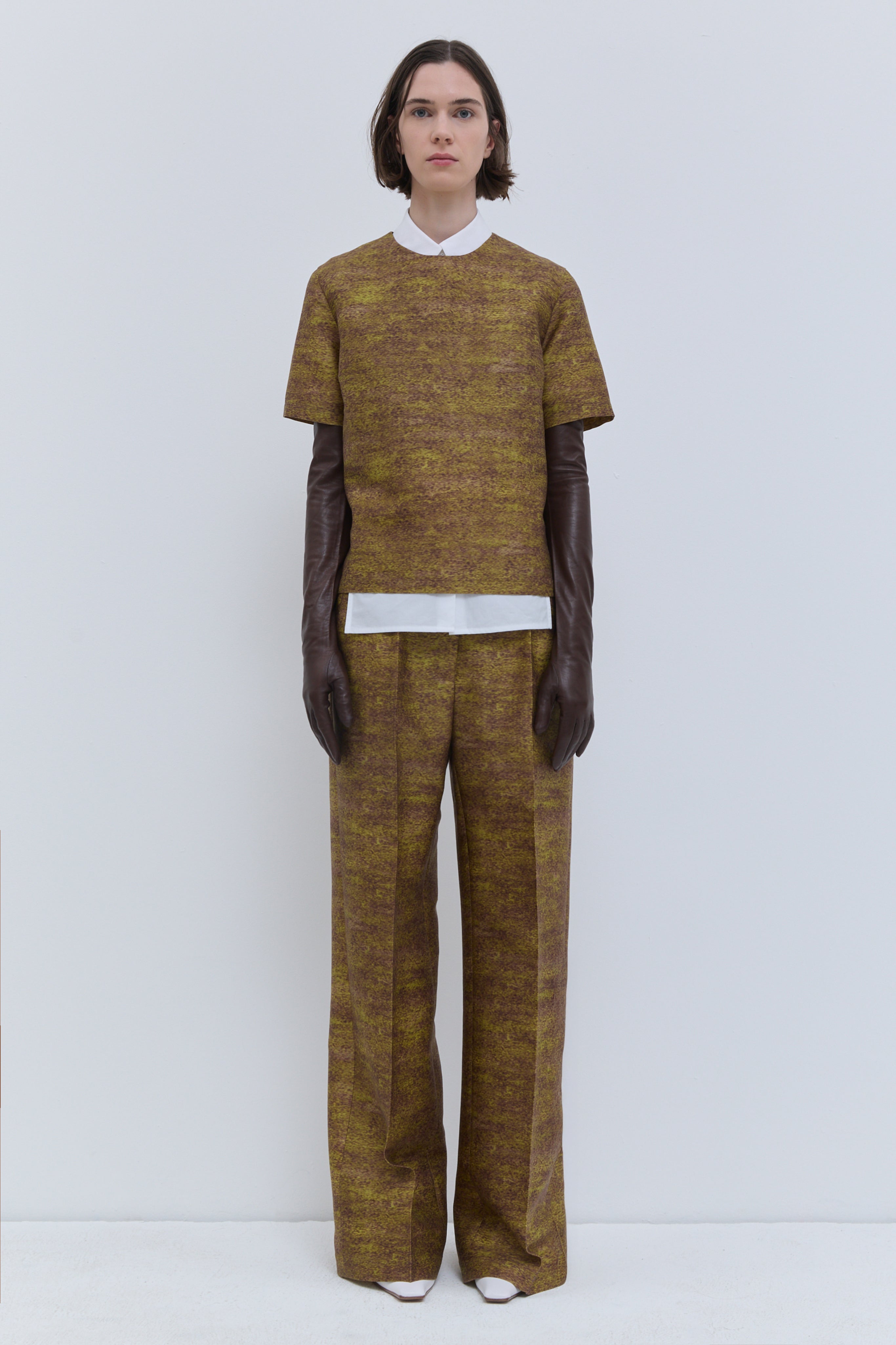 Front view of the Gold Storm printed wool and silk fitted short-sleeve top with side slits.