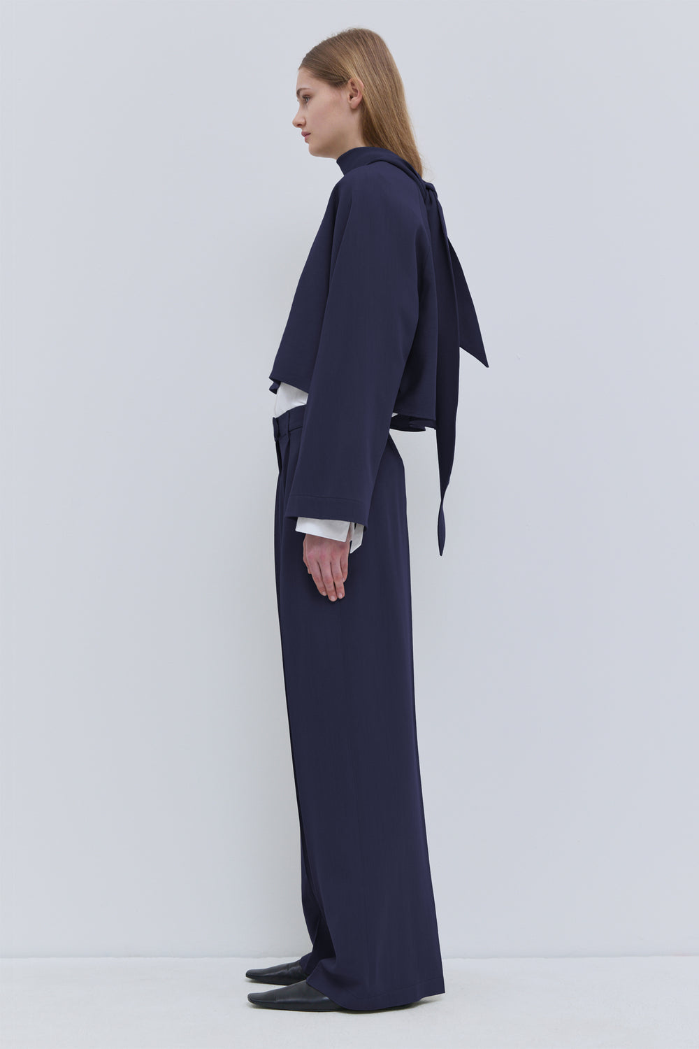 Side view of dark navy cropped wool top with flowing scarf detail Christian Wijnatns