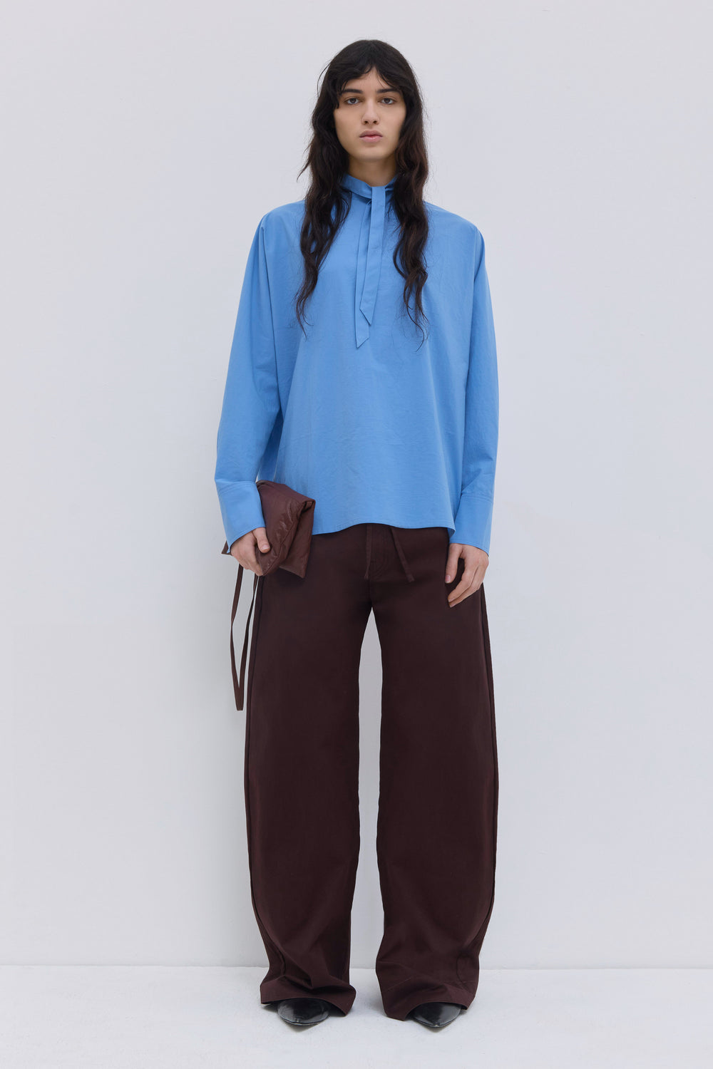 Front view of the Tuvra cerulean batwing sleeve blouse with stand collar and oversized silhouette.