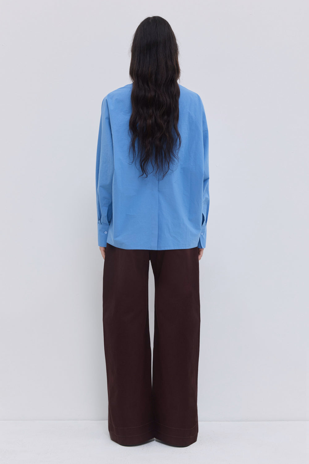 Cerulean batwing sleeve blouse with stand collar, front tie and clean minimalist design.